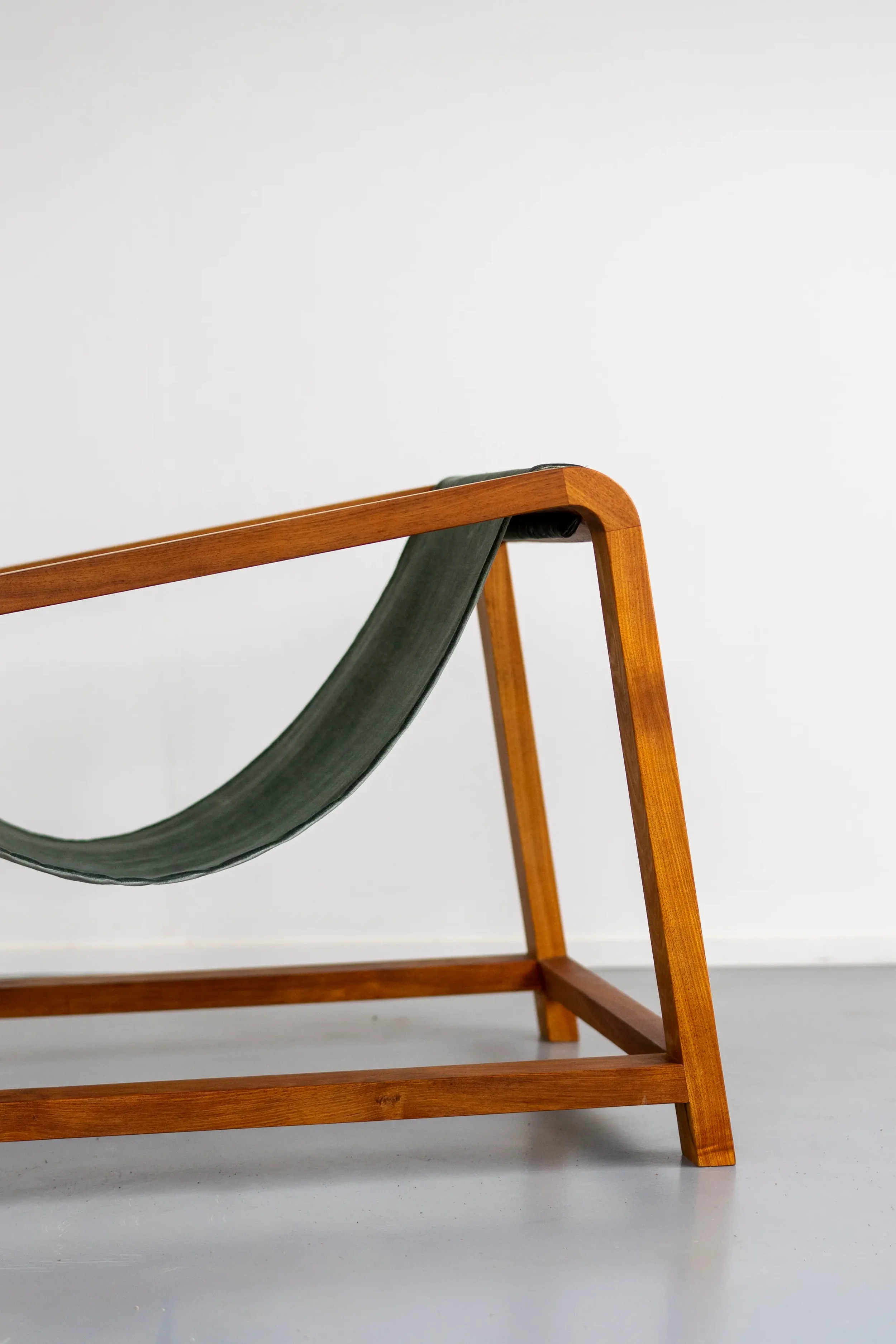 Wrangler chair in Tasmanian Blackwood and ochre velour sling. Close up view, highlighting the soft curved edges and detail in the wood grain. Hand made on the Surf Coast by Georgie Wood. 