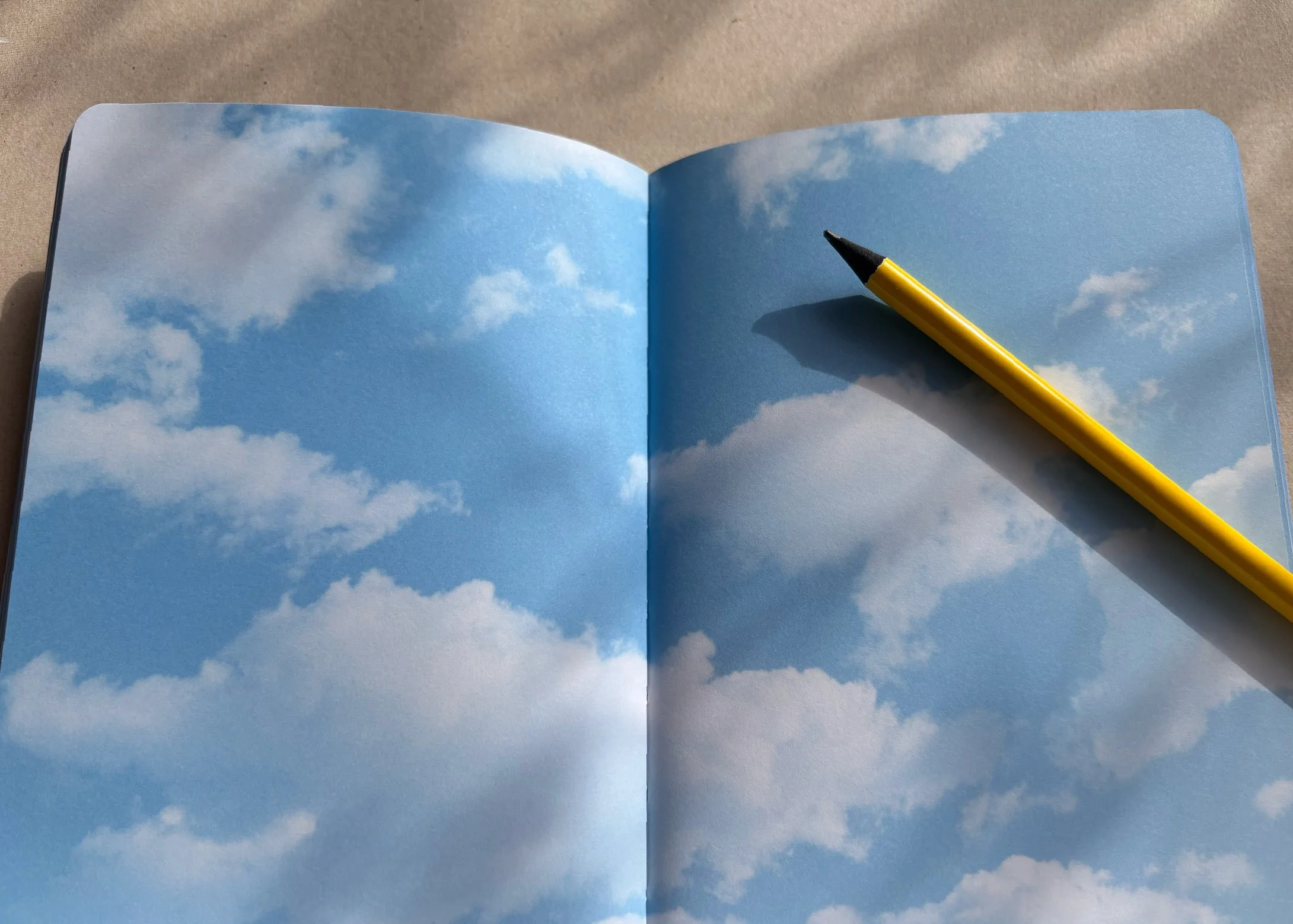 eine neue Seite im aufgeschlagenen Notizbuch und ein Stift