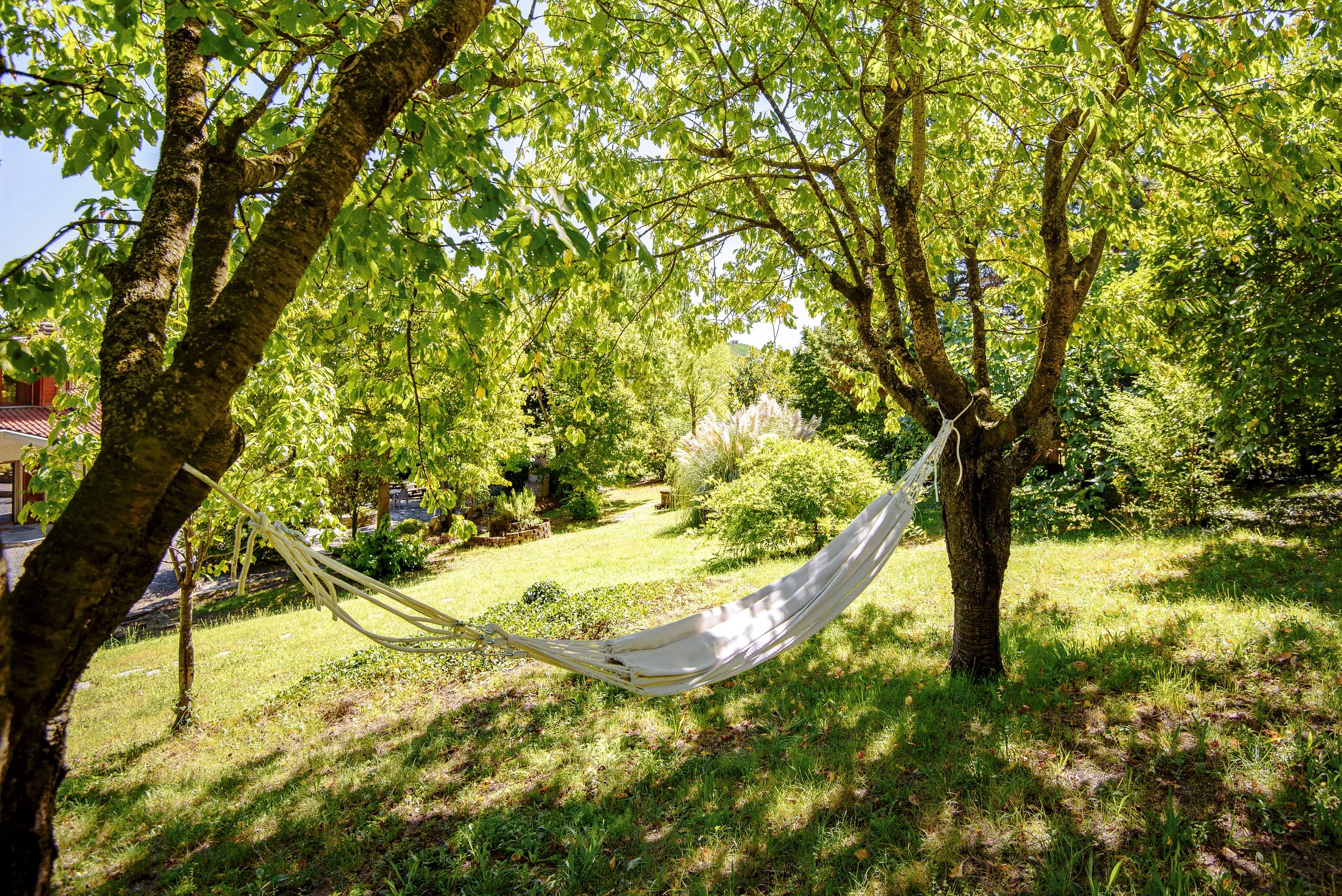 La Collina di Cesare_Modern villa in UNESCO vineyards with Panoramic views and heated swimming pool_hammock in the large garden with panoramic UNESCO views