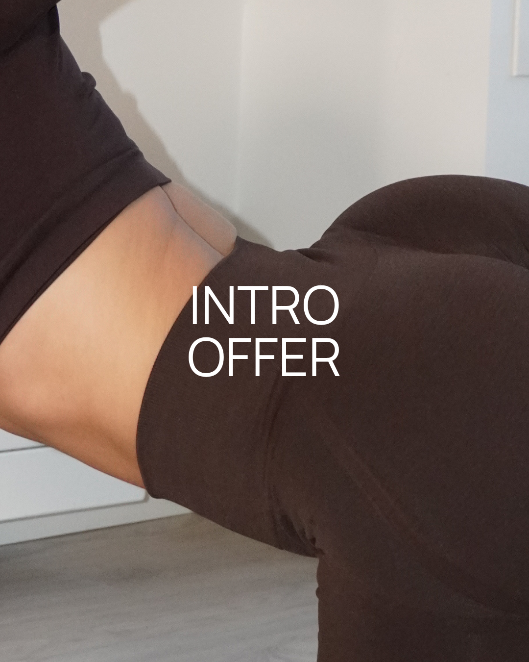 Close-up of a person's lower back and hip area wearing a black top and black pants, with white text saying 'INTRO OFFER' over the image.