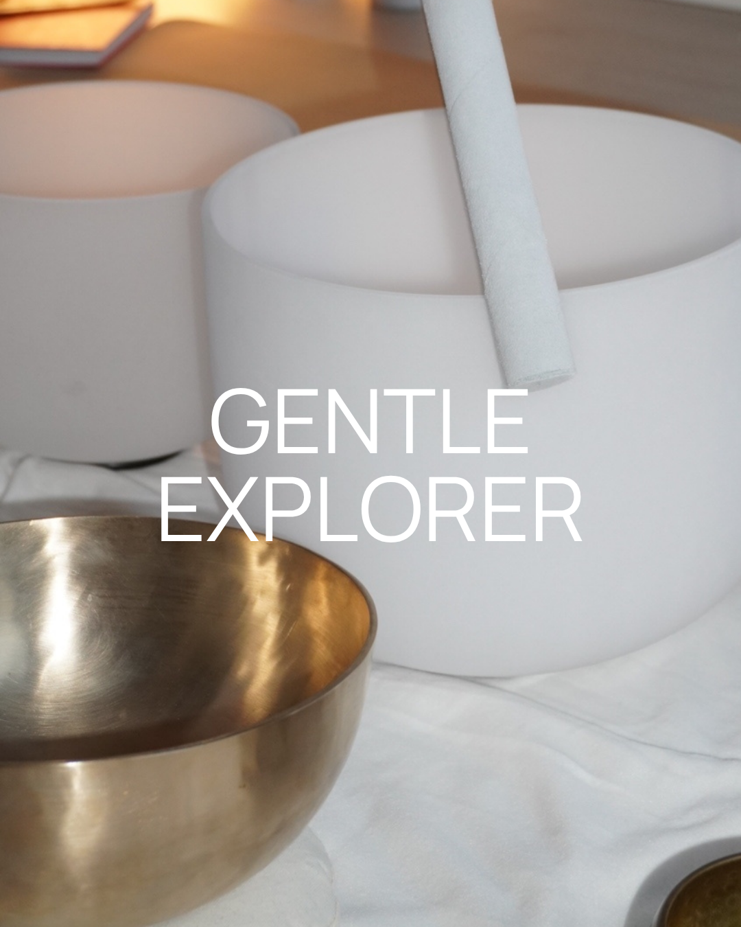 Minimalist white round containers with one containing a white object and metal bowls, with the text "Gentle Explorer" overlaid.