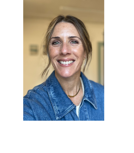 A close-up of a woman with shoulder-length wavy blonde hair, smiling softly, wearing a white sleeveless top.