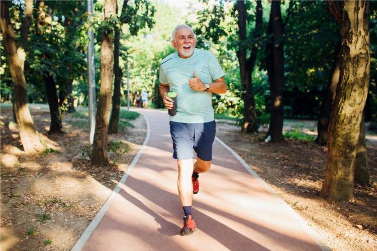 Older man jogging on a tree-lined park path