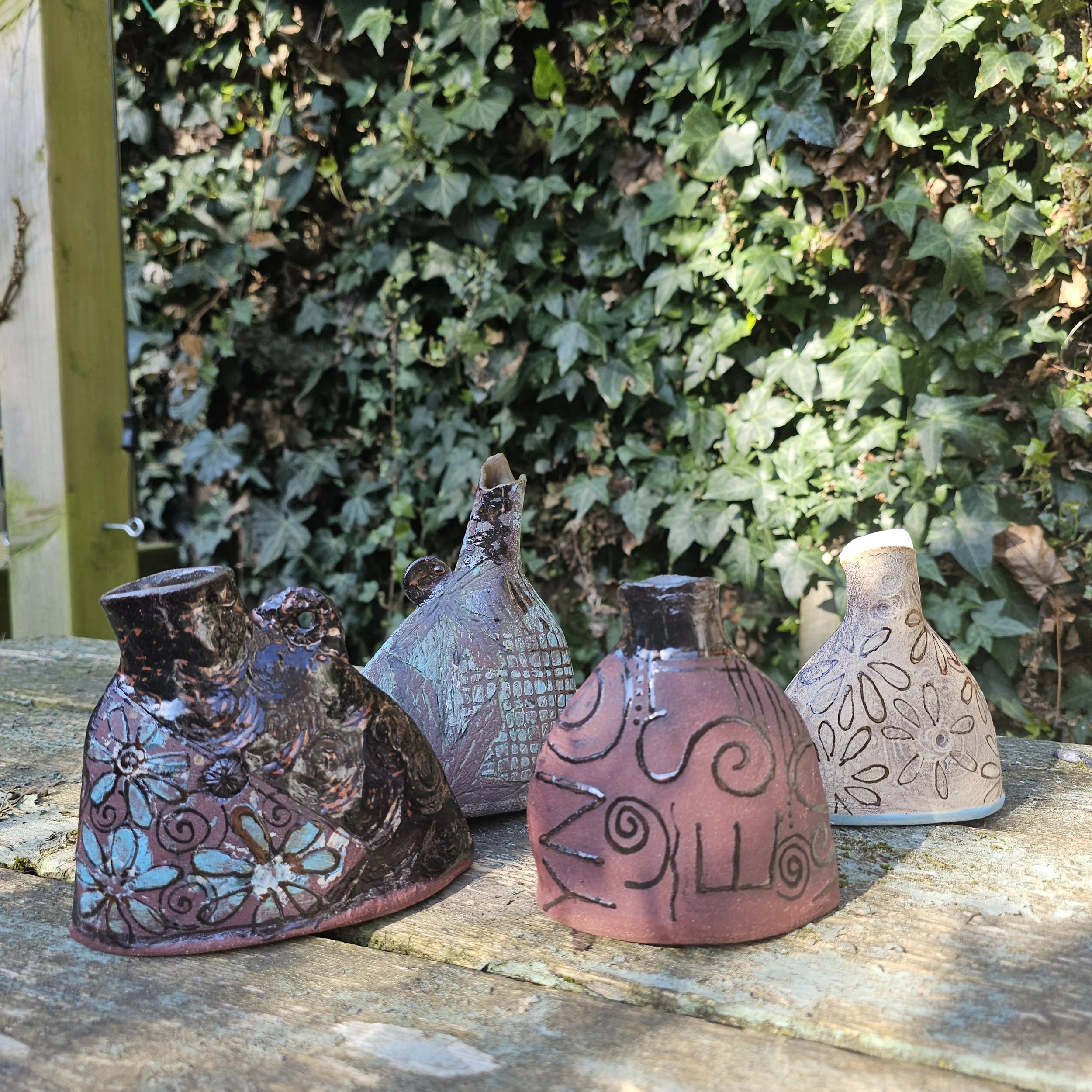 red and wild clay vessels, glazed interiors and  texts. only the 2 on the right available £40 each