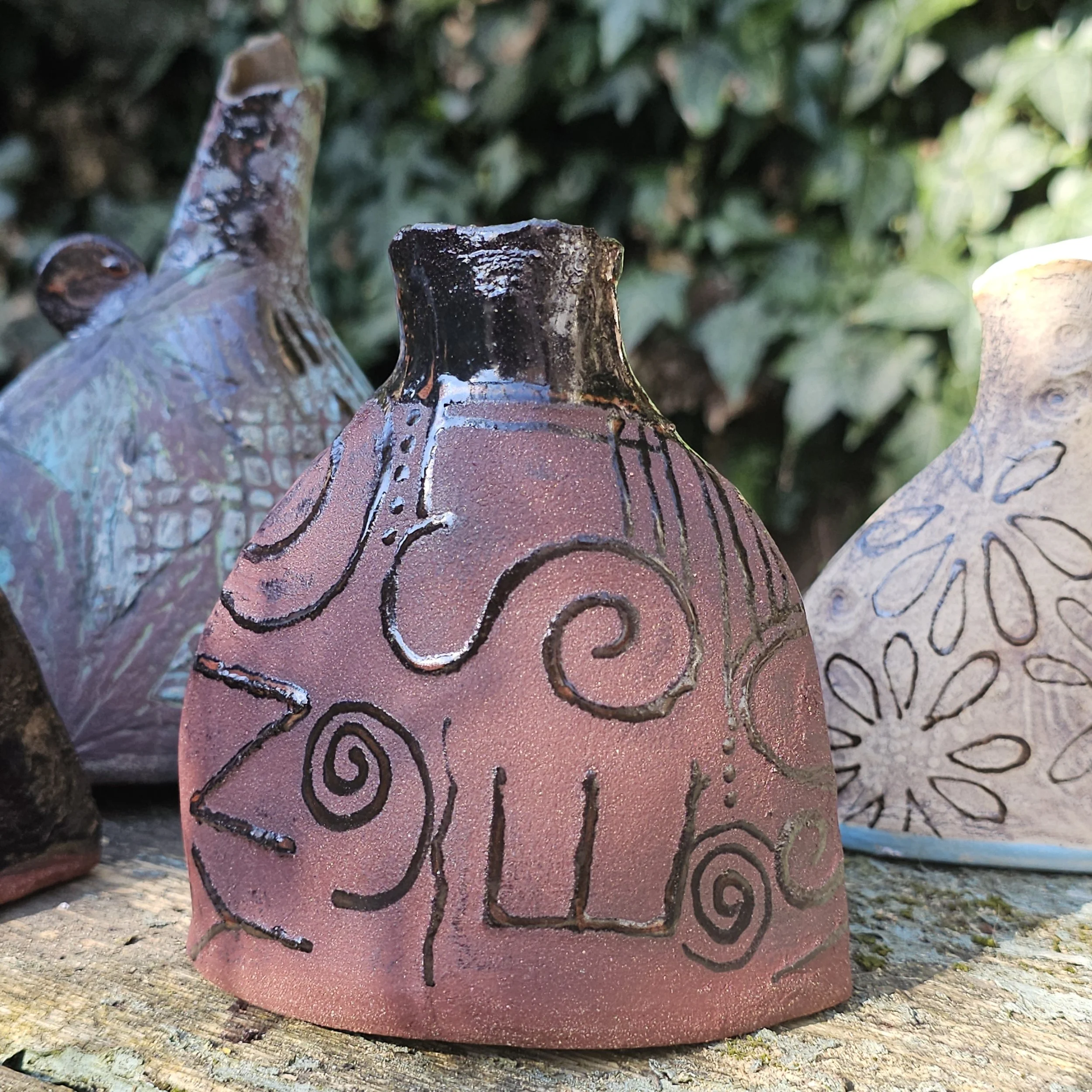 red stoneware protest vases, copper glaze inside and details  £40