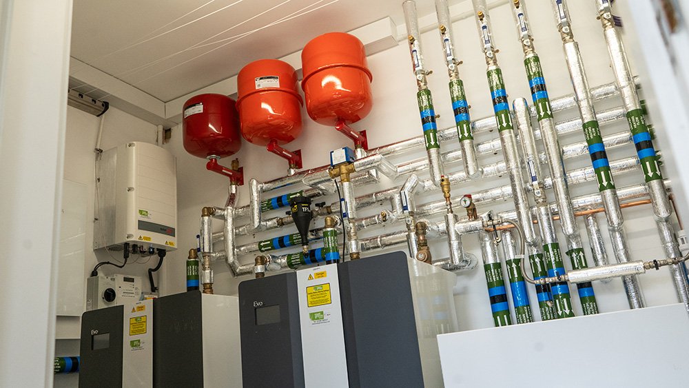 Heating system with pumps, pipes, and expansion tanks in a utility room