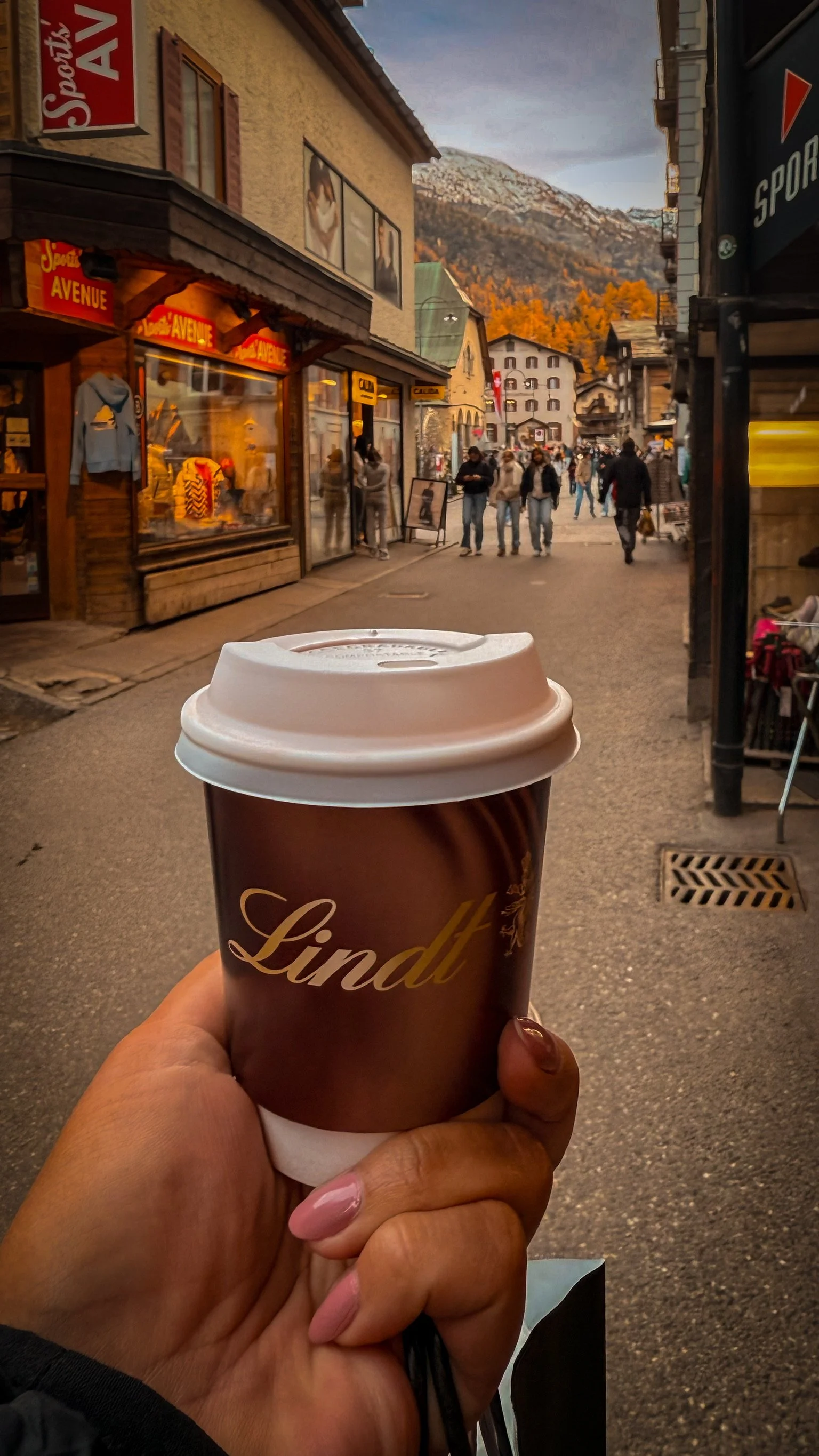 Enjoying Lindt hot chocolate while walking through Zermatt village