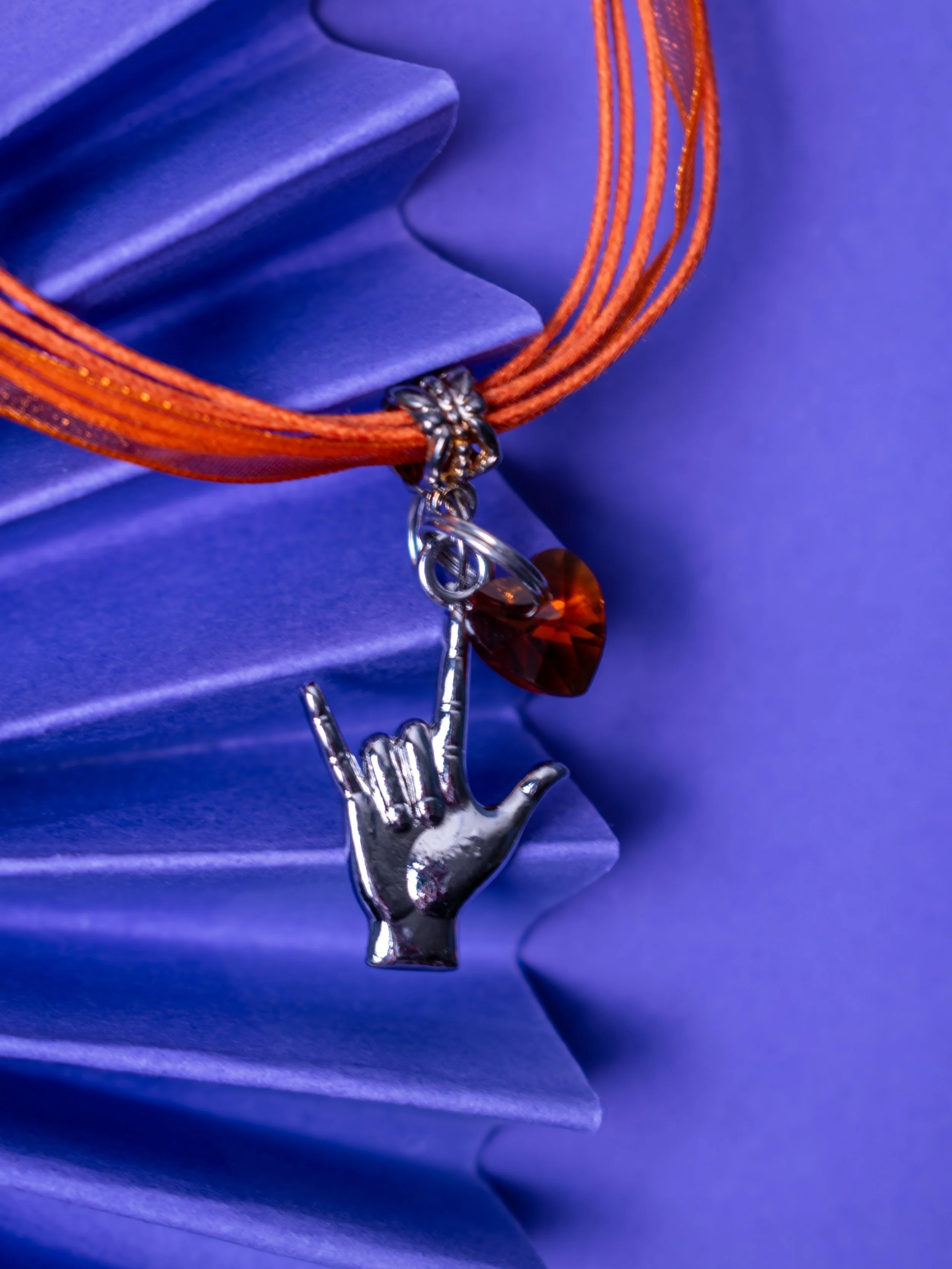 Orange neckleace on fan.jpg