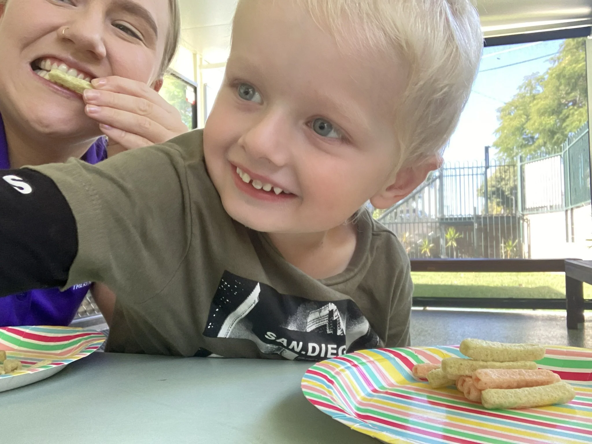 Speech Pathologist Emilie Adams working with children and kids with disabilities at Lifespan Therapies in Strathpine, North Brisbane. Pictured during a kids speechie session with a child during a speech therapy feeding session.