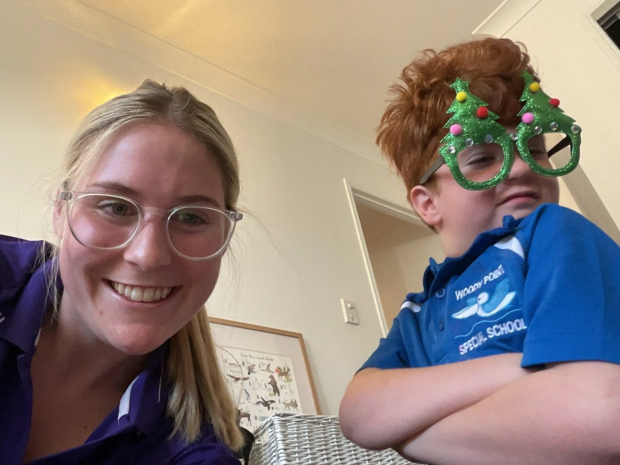 Occupational Therapist Georgia Black pictured smiling with a young child during a therapy session, a community home visit.