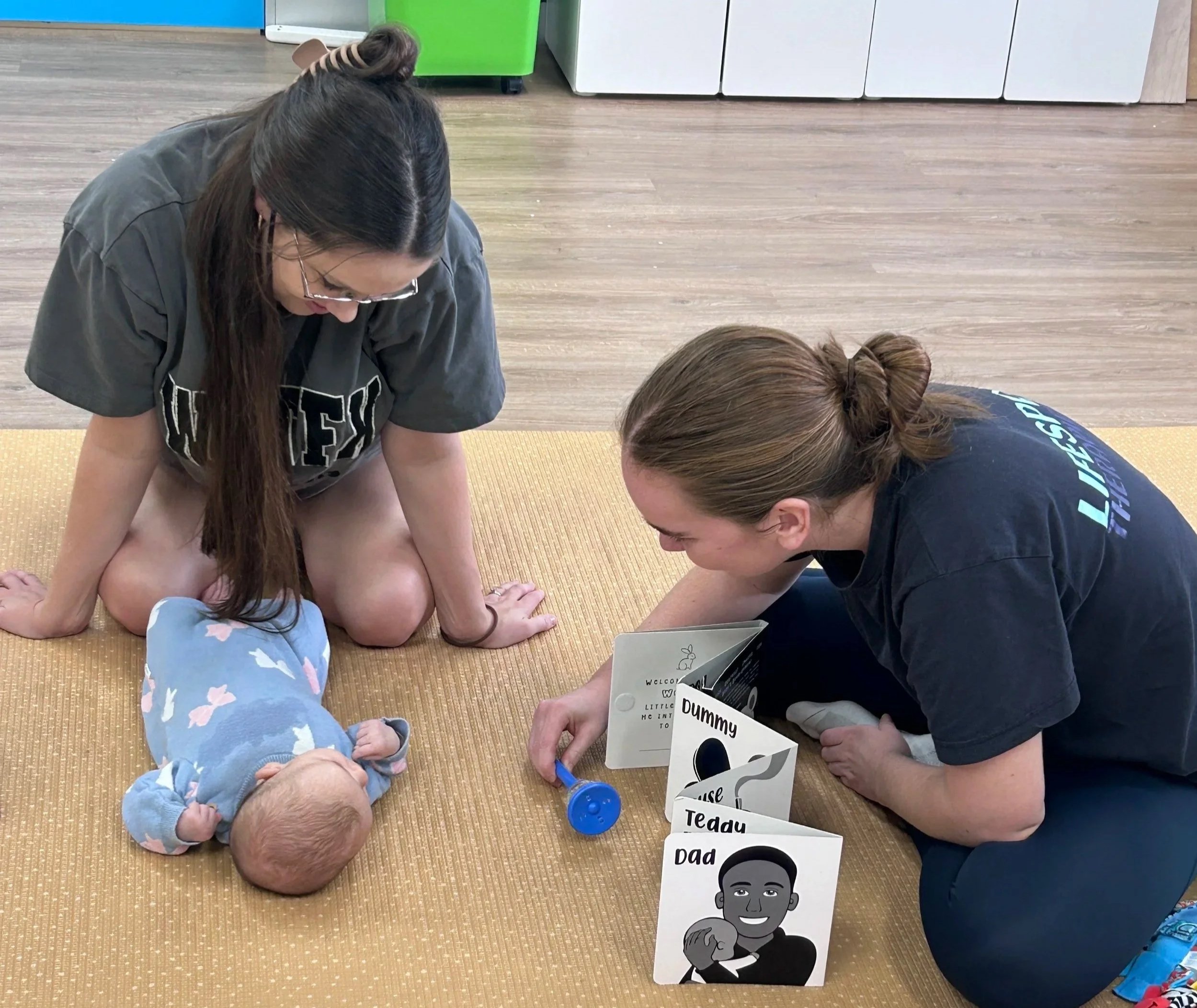 Young child developing fine motor and play skills during a paediatric therapy activity