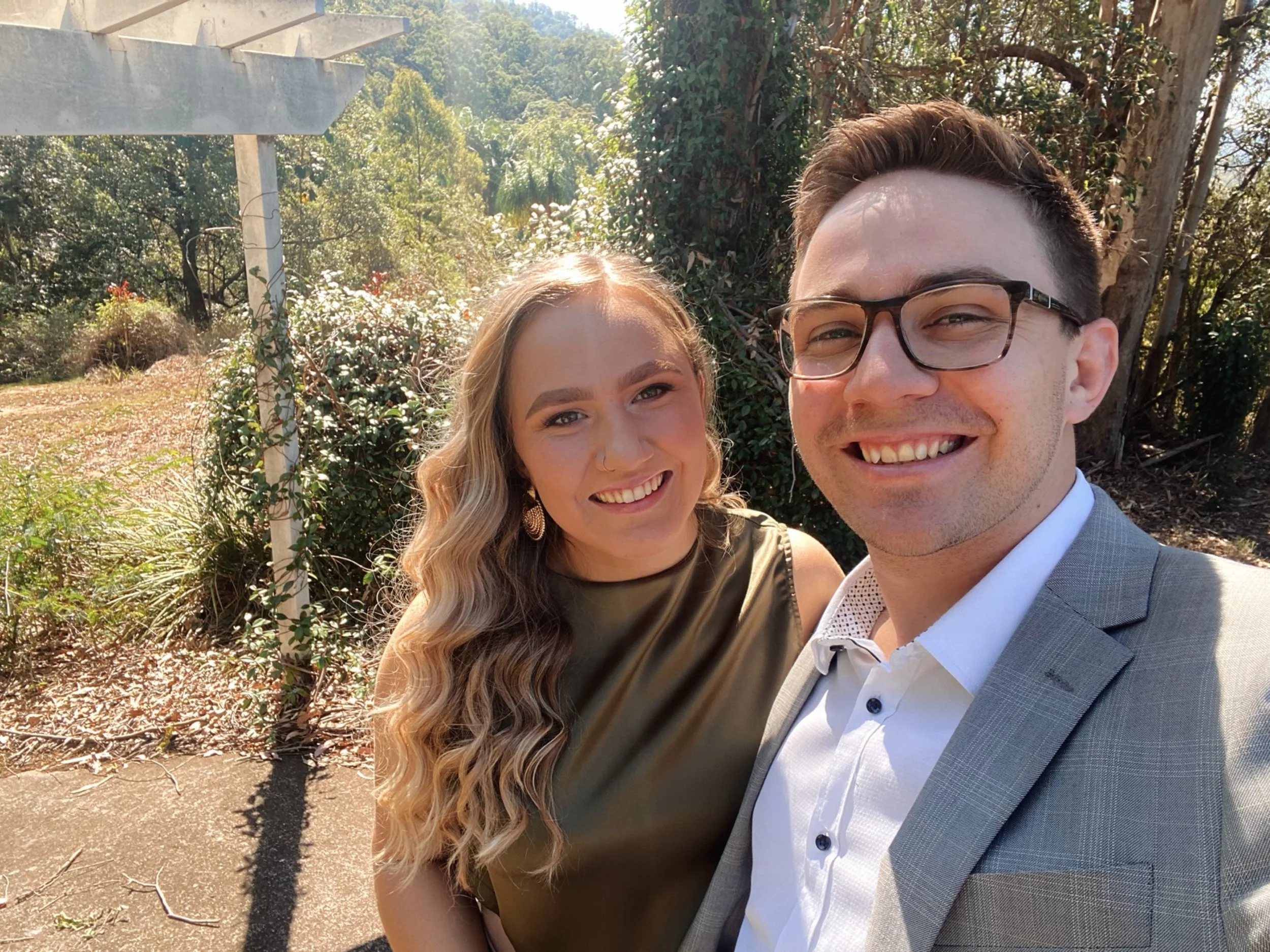 Speech Pathologist Courtney Haim working with children and kids with disabilities at Lifespan Therapies in Strathpine, North Brisbane. Pictured smiling with her partner, both in formal clothing.