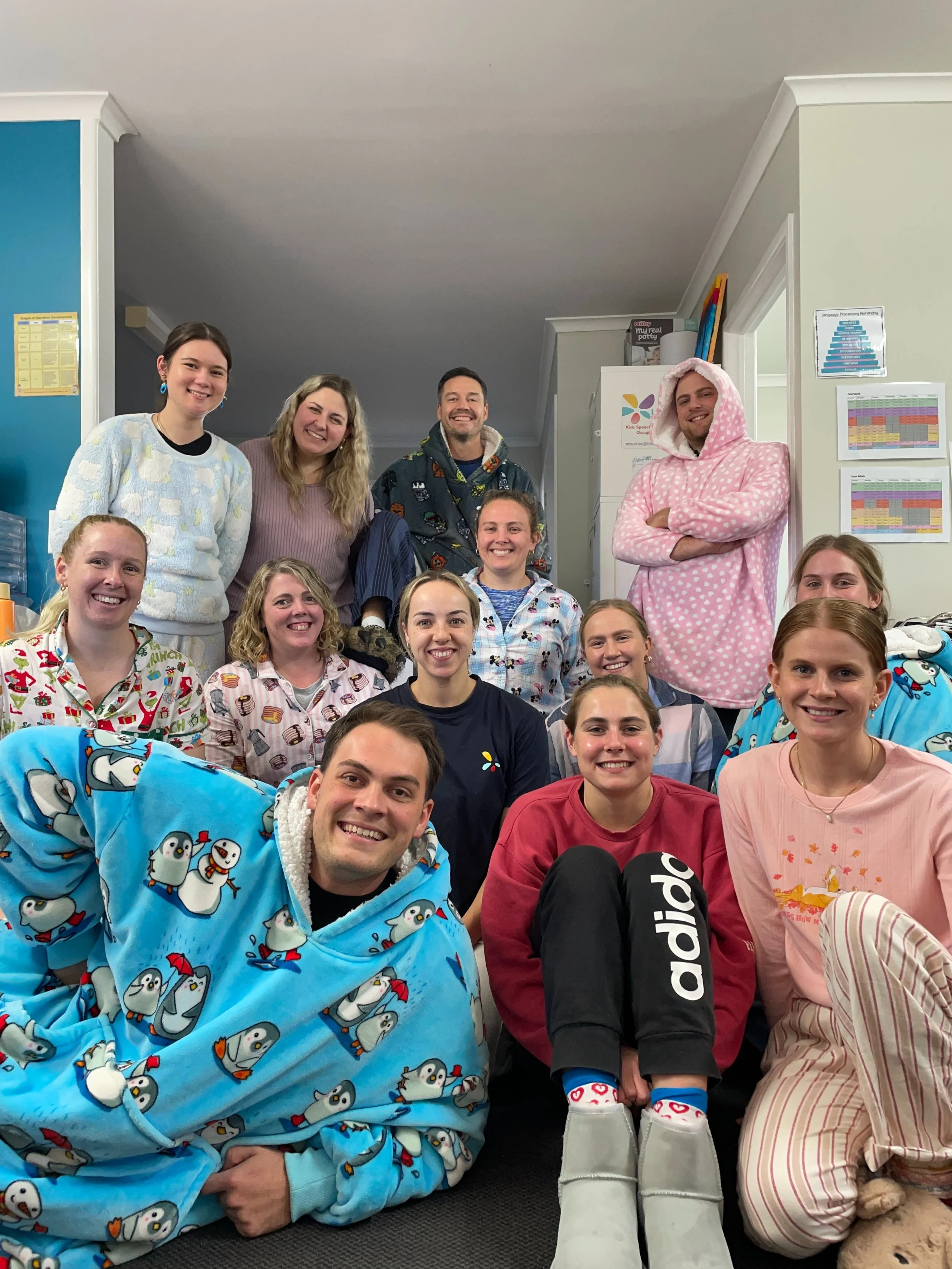 Group staff photo of Lifespan Therapies participating in a pajama dress up day. Pictured in the Lifespan Therapies clinic in North Brisbane, offering children's physiotherapy, occupational therapy, speech pathology for kids, babies, and children.