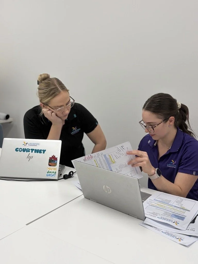 Paediatric allied health therapists collaborating on clinical planning at Lifespan Therapies in Brendale