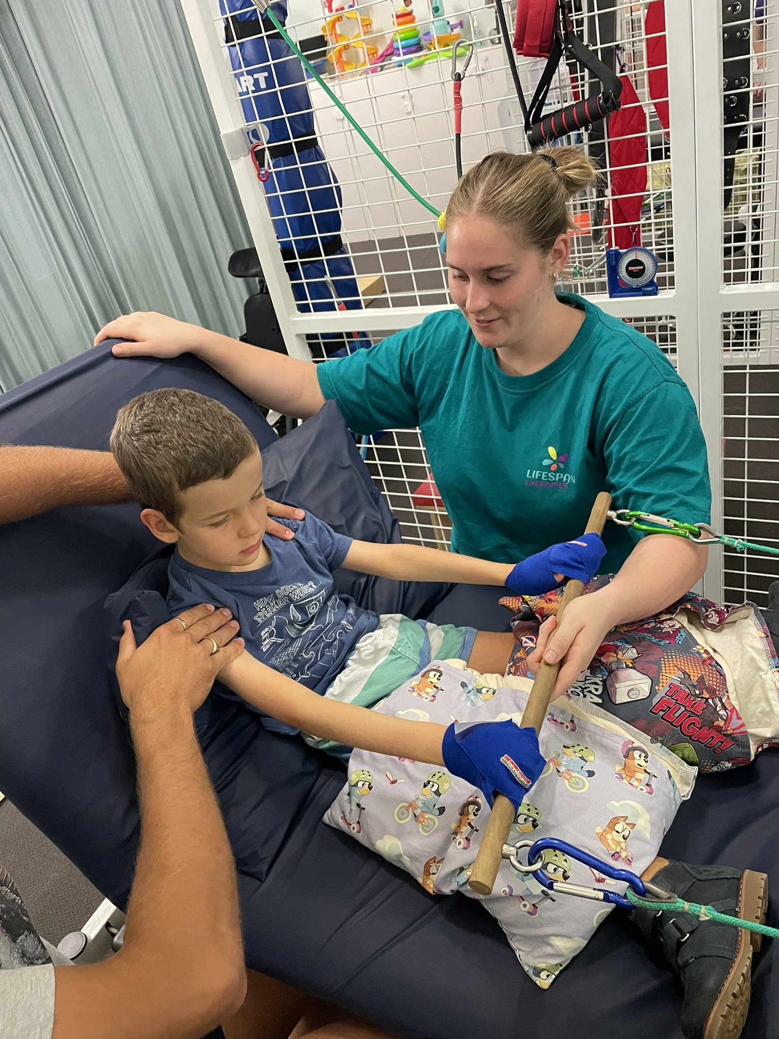 Paediatric occupational therapist supporting upper limb and bimanual skill development