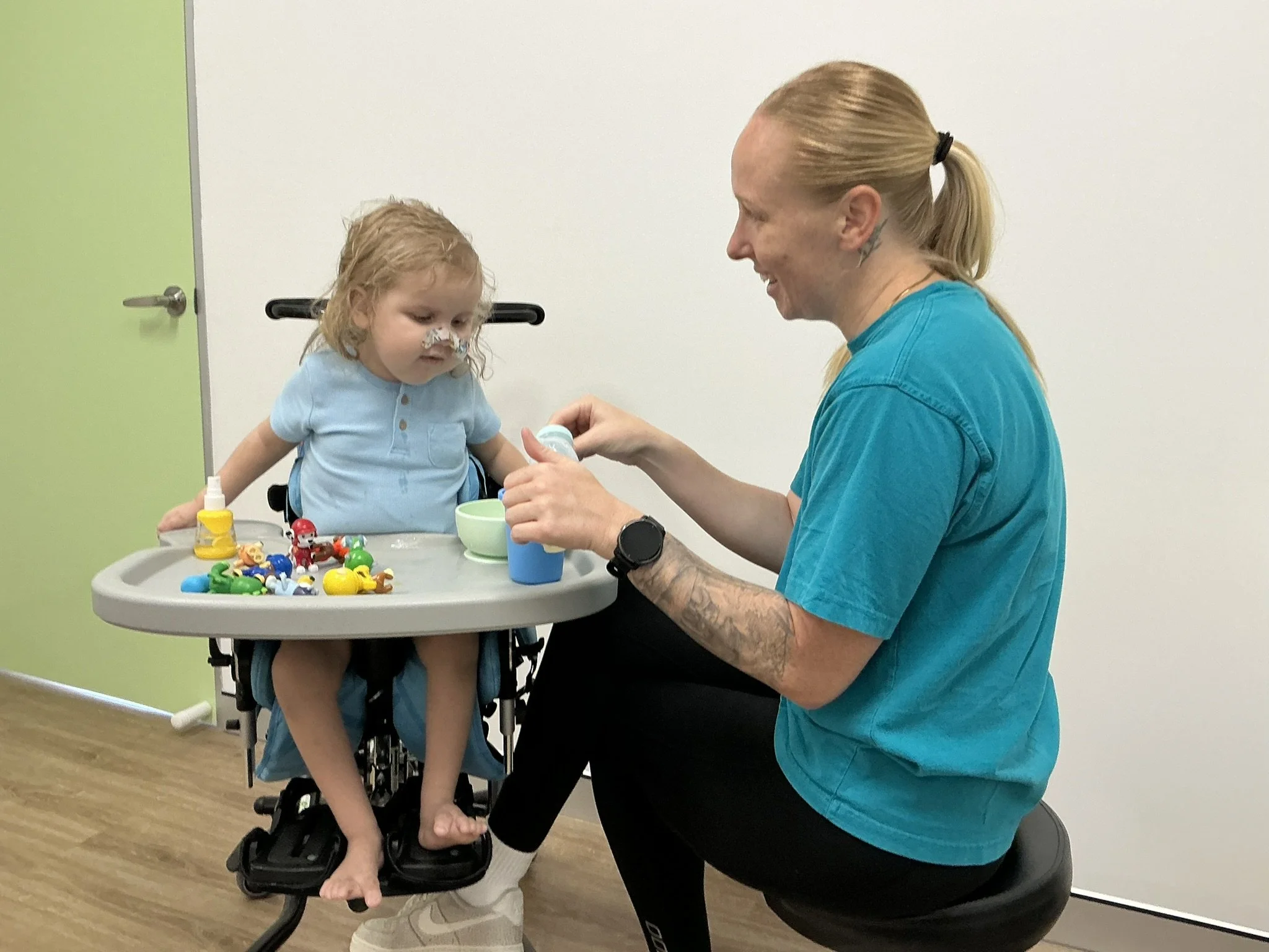 Paediatric speech pathologist supporting feeding, chewing and swallowing skills in a child