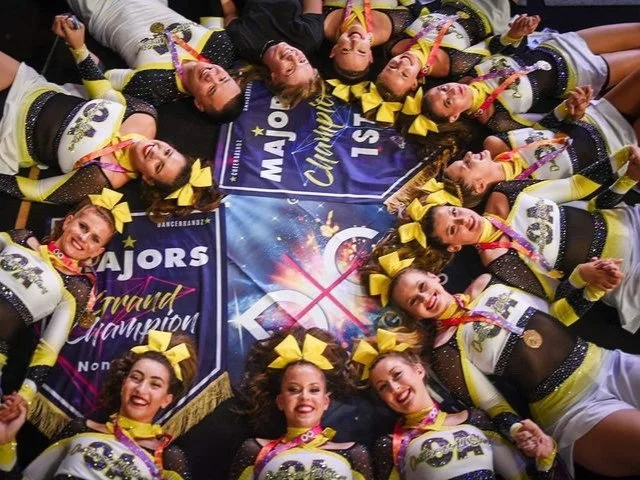 Occupational Therapist Emma Joss working with children and children with disabilities at Lifespan Therapies in Strathpine, North Brisbane. Pictured with her cheerleading team lying on the floor in a circle and smiling.