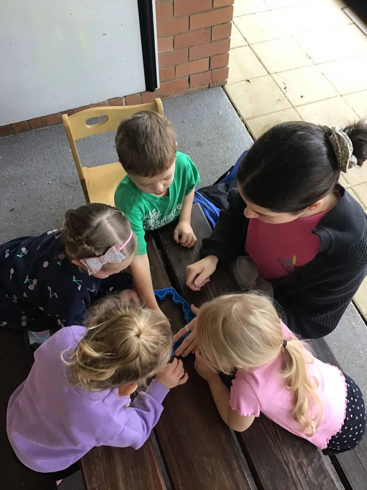 Allied health therapist collaborating with early childhood educators to support child development