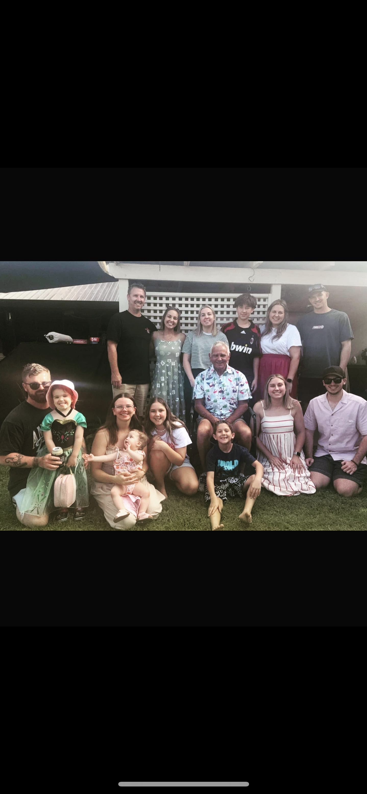 Front Office Coordinator Aly Imeson working to support children and kids with disabilities at Lifespan Therapies in Strathpine, North Brisbane. Pictured smiling in a family photo.