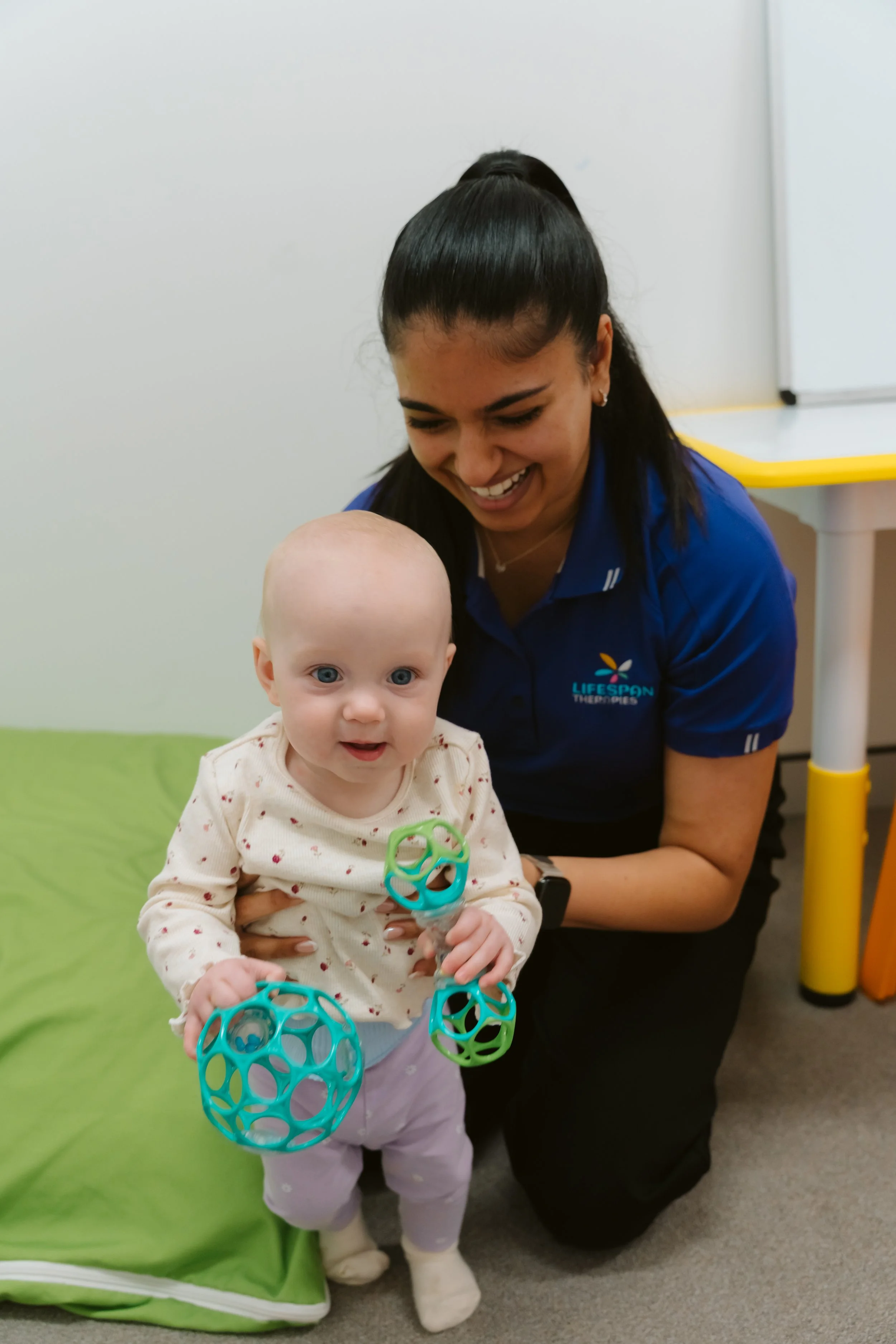 Paediatric speech pathologist supporting early communication and first words in a young child