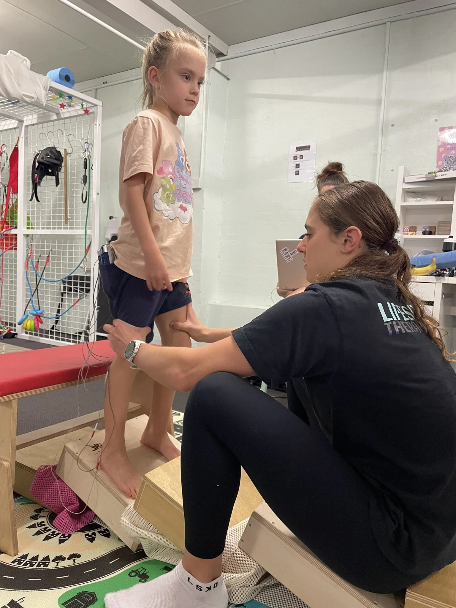 Child completing movement and coordination activities with a paediatric physiotherapist