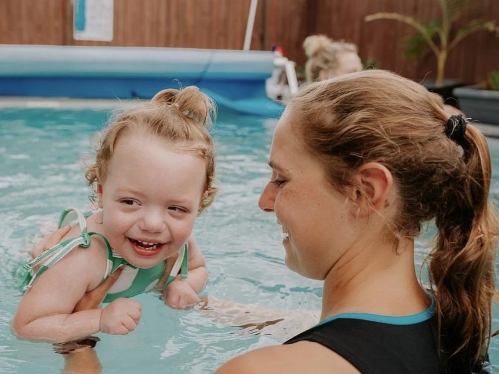 Physiotherapist Prudie White working with children and children with disabilities at Lifespan Therapies in Strathpine, North Brisbane. Picture in a swimming pool with a smiling child during a hydrotherapy session.