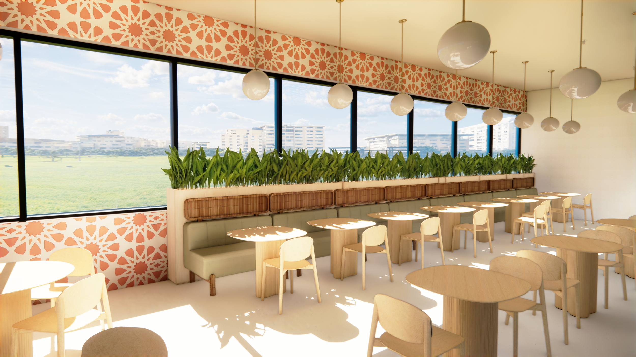 Bright daytime interior of a modern cafe with light wooden tables and chairs, a long banquette with green cushions, a white divider with green plants, and large windows showing a green field and city buildings, decorated with a geometric pink and whi
