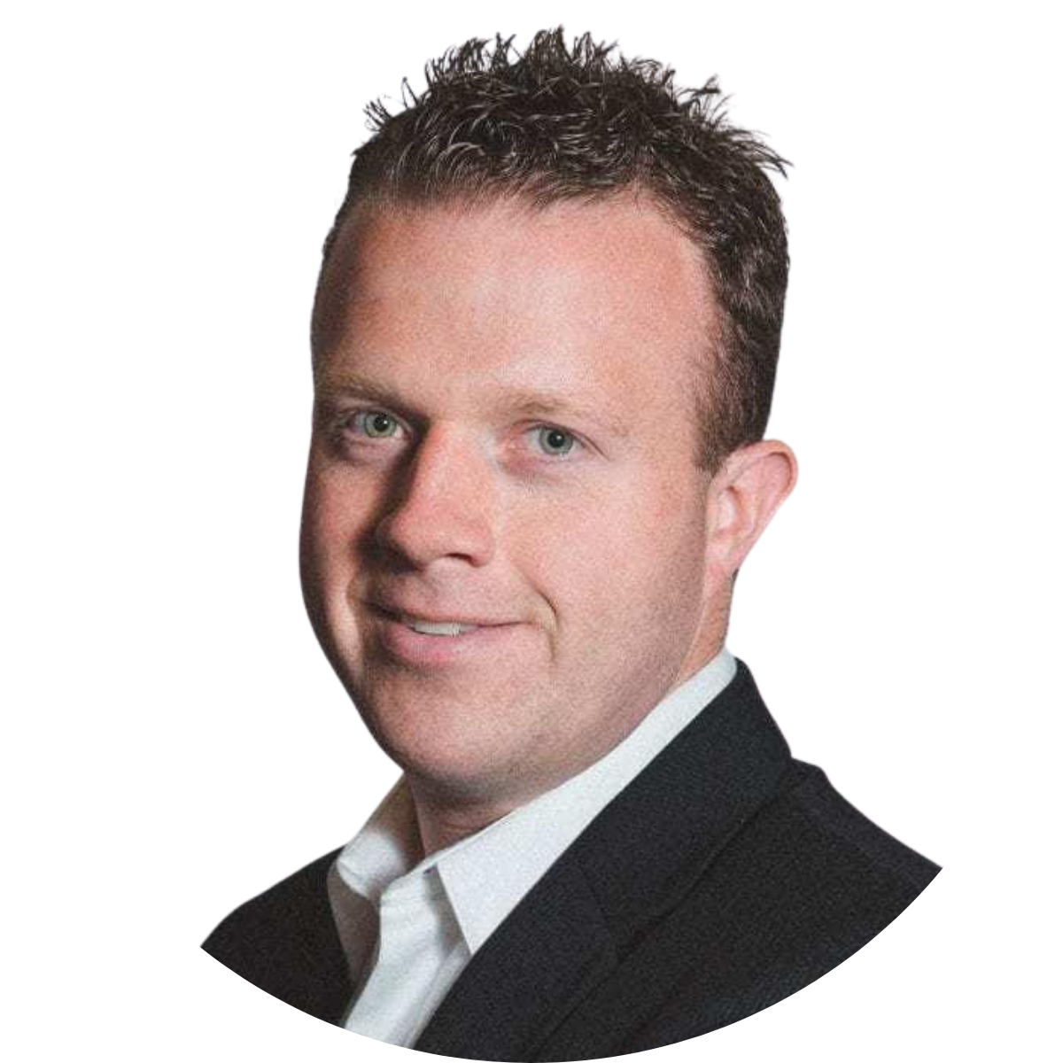 Professional headshot of a man with short, curly brown hair, blue eyes, wearing a white shirt and dark blazer, smiling slightly.