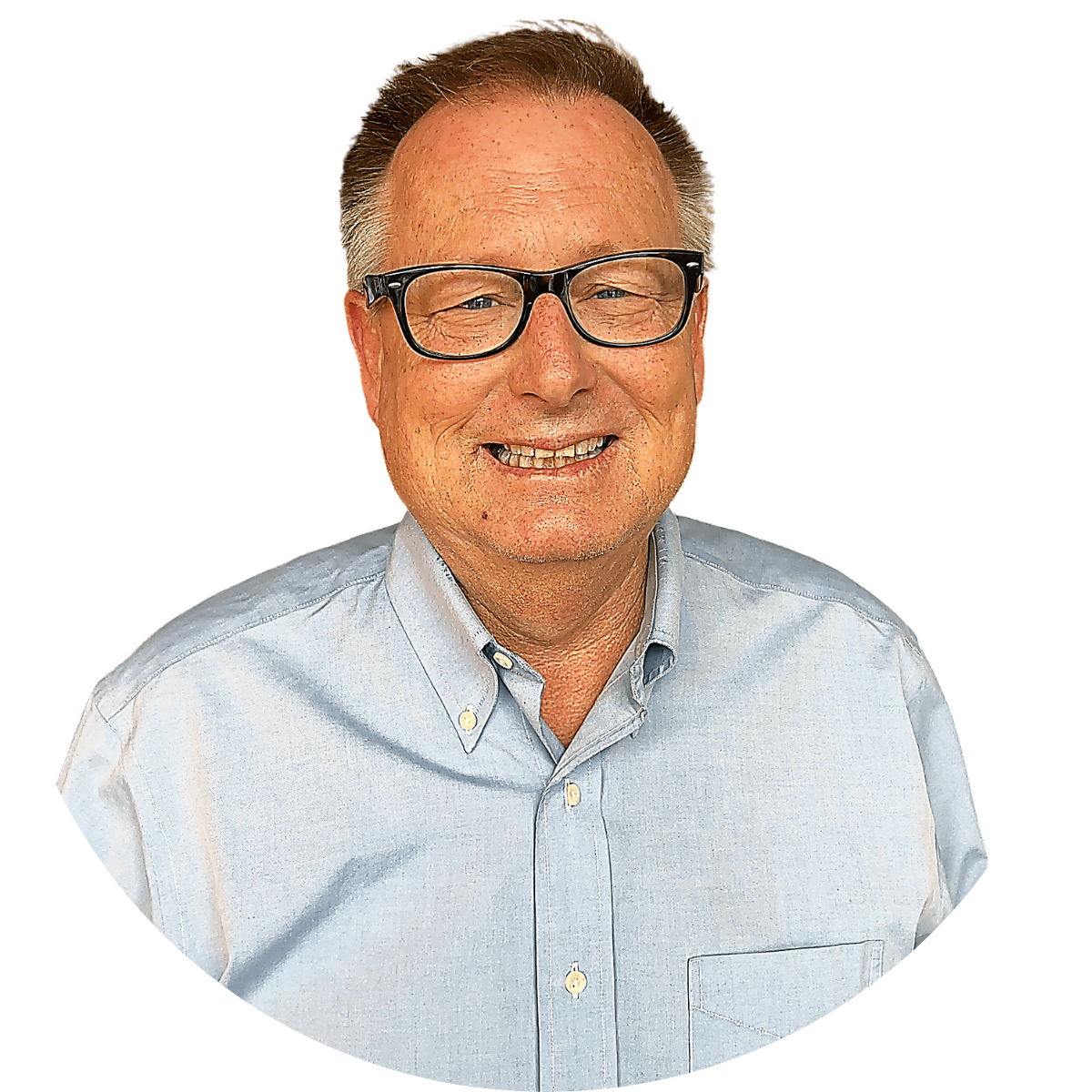 A middle-aged man with glasses and short gray hair, smiling and wearing a light blue button-up shirt, standing against a white and black background.