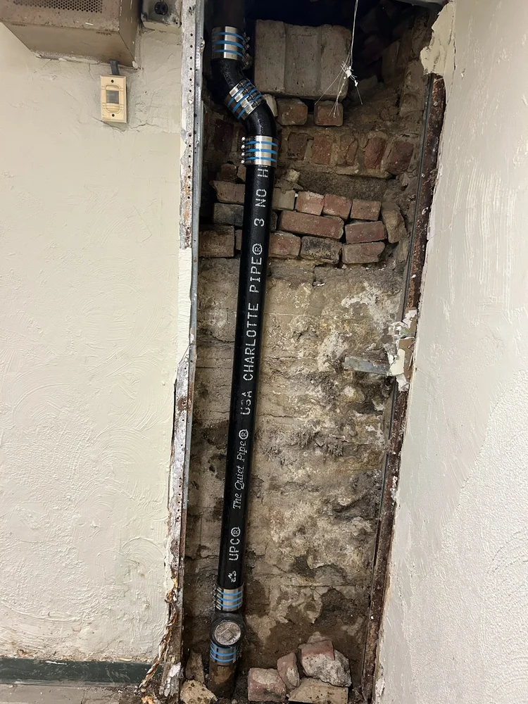 New drain line run inside an opened wall
