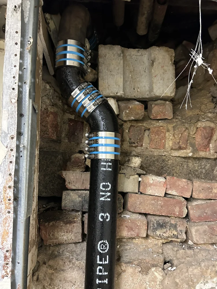 New cast iron drain pipe joined with stainless couplings