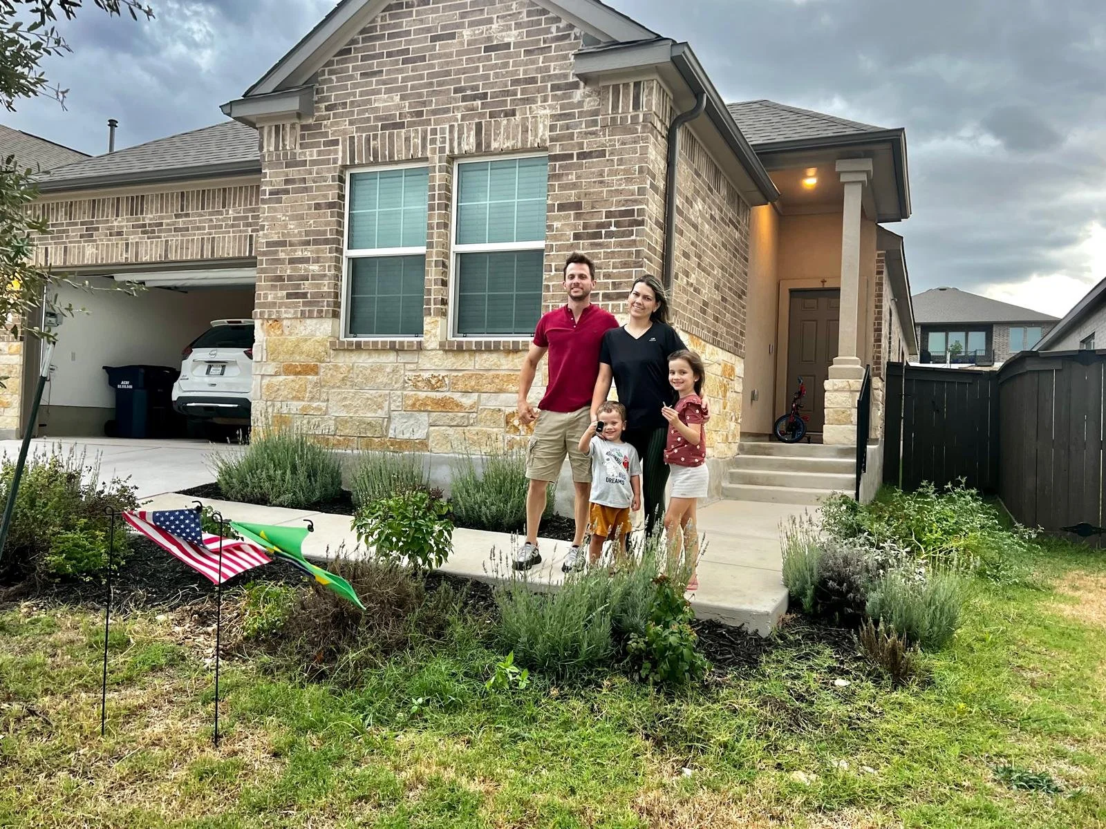 Lucas and Aline in front of their new home.jpg