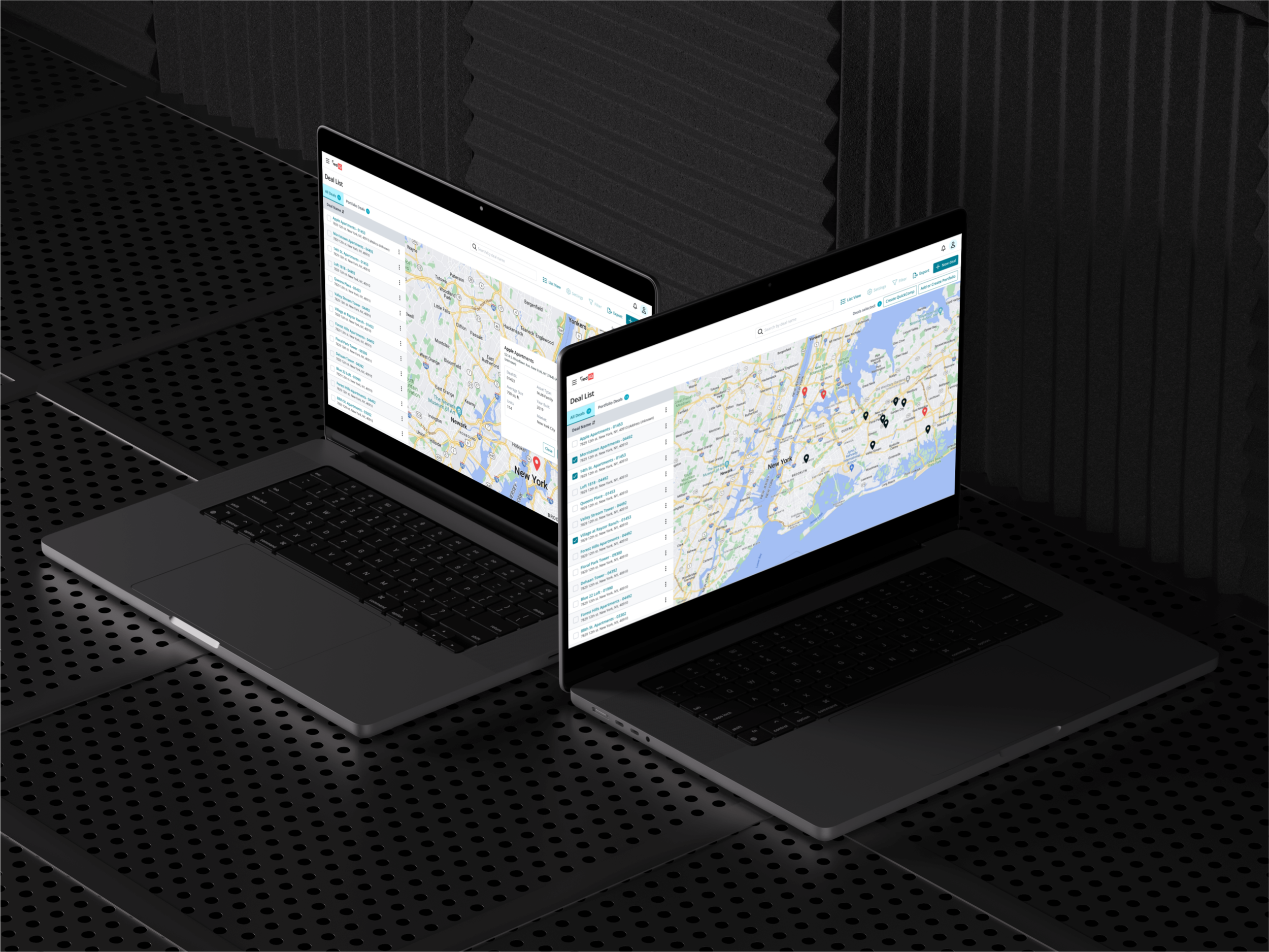 Two laptop computers on a perforated black table, displaying maps and deal lists on their screens in a dark room with soundproof foam panels.