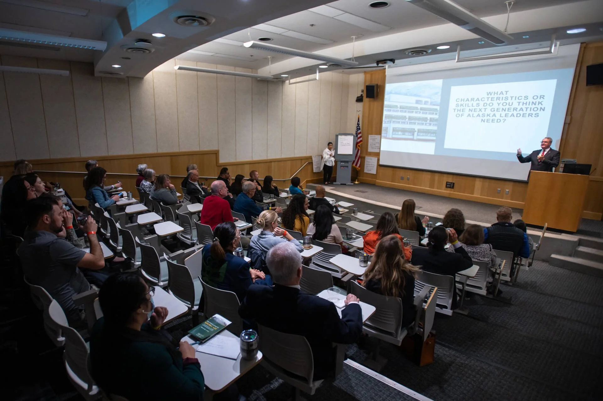 Rasmuson Hall classroom filled with participants viewing a presentation.