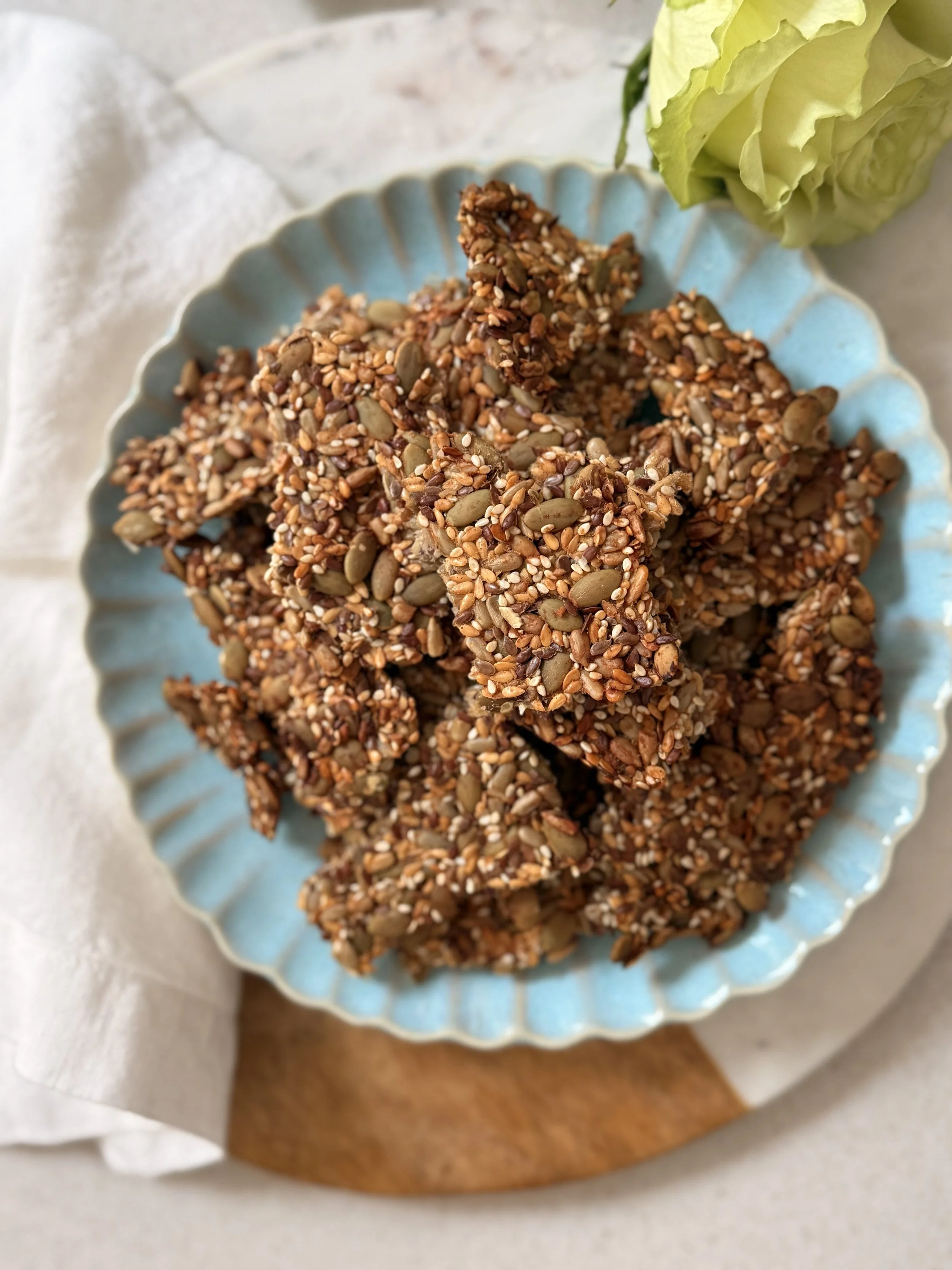 Apple and cinnamon seeded crackers on a light blue plate