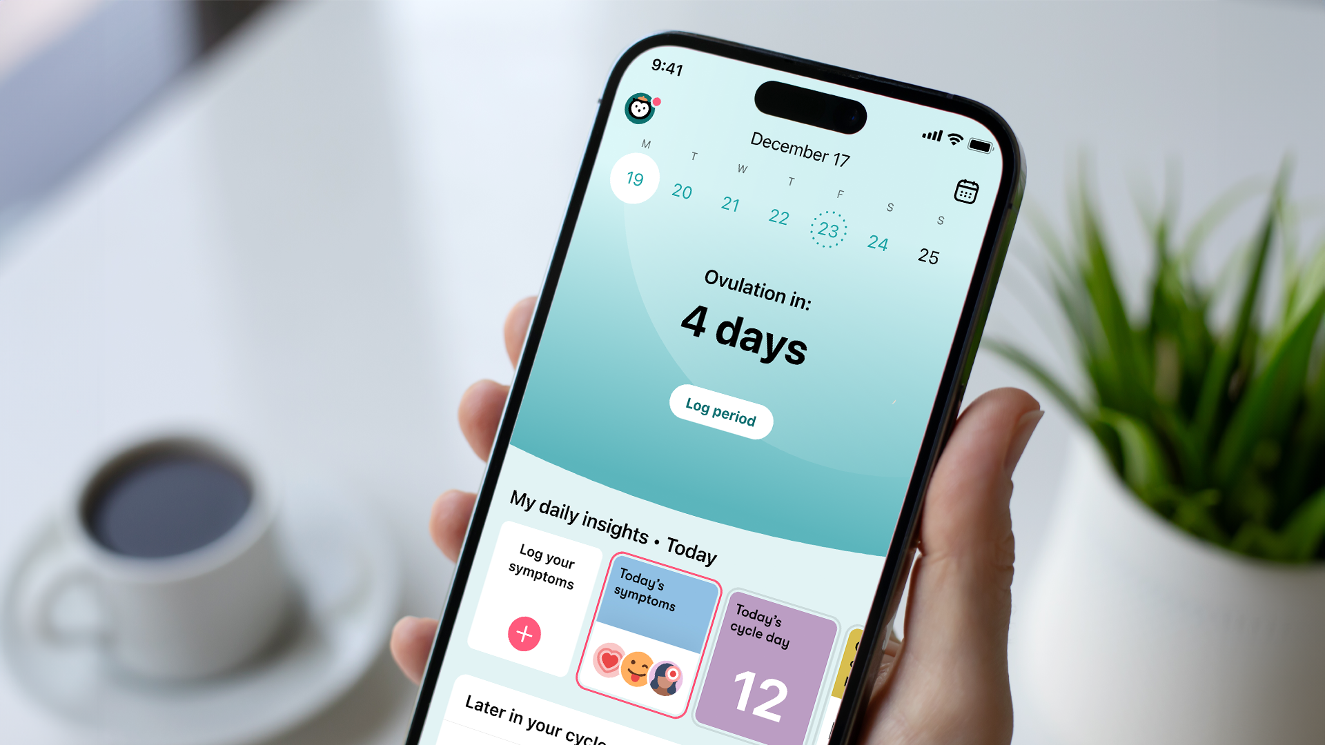 A hand holds a phone showing the Flo Health fertility tracking app