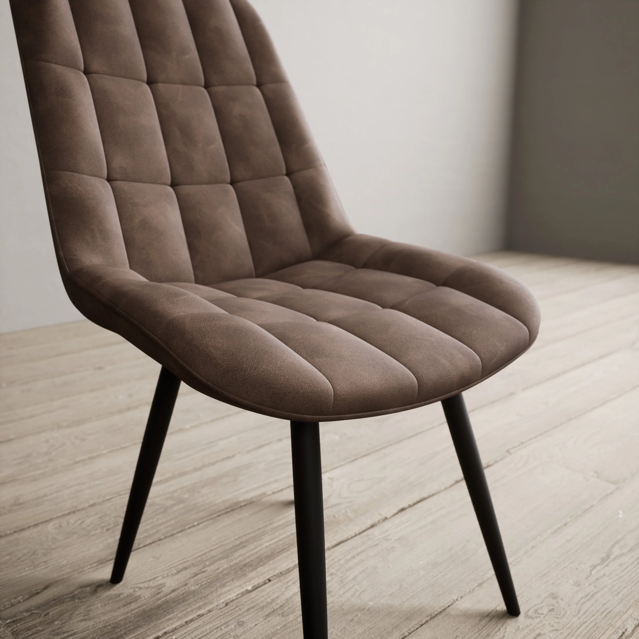 Brown upholstered chair with tufted cushion, black angled legs, on wooden floor.