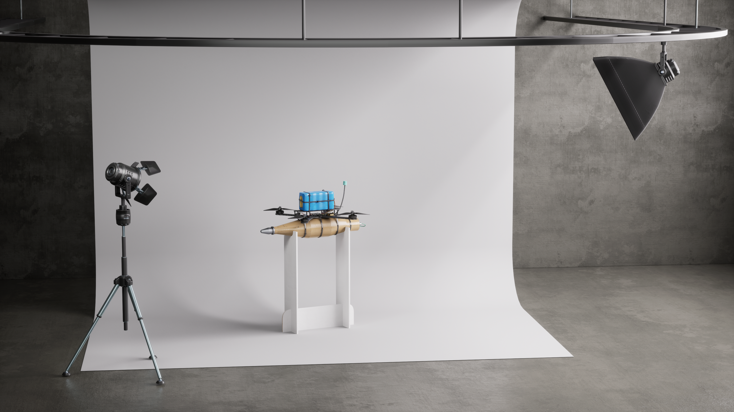A drone with a water container mounted on top, set up on a white backdrop in a photography studio with lighting equipment.
