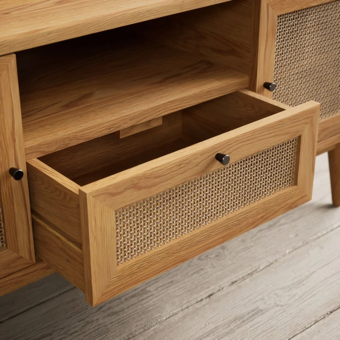 A wooden drawer with a woven rattan front panel, partially open, inside a piece of furniture with similar design elements.