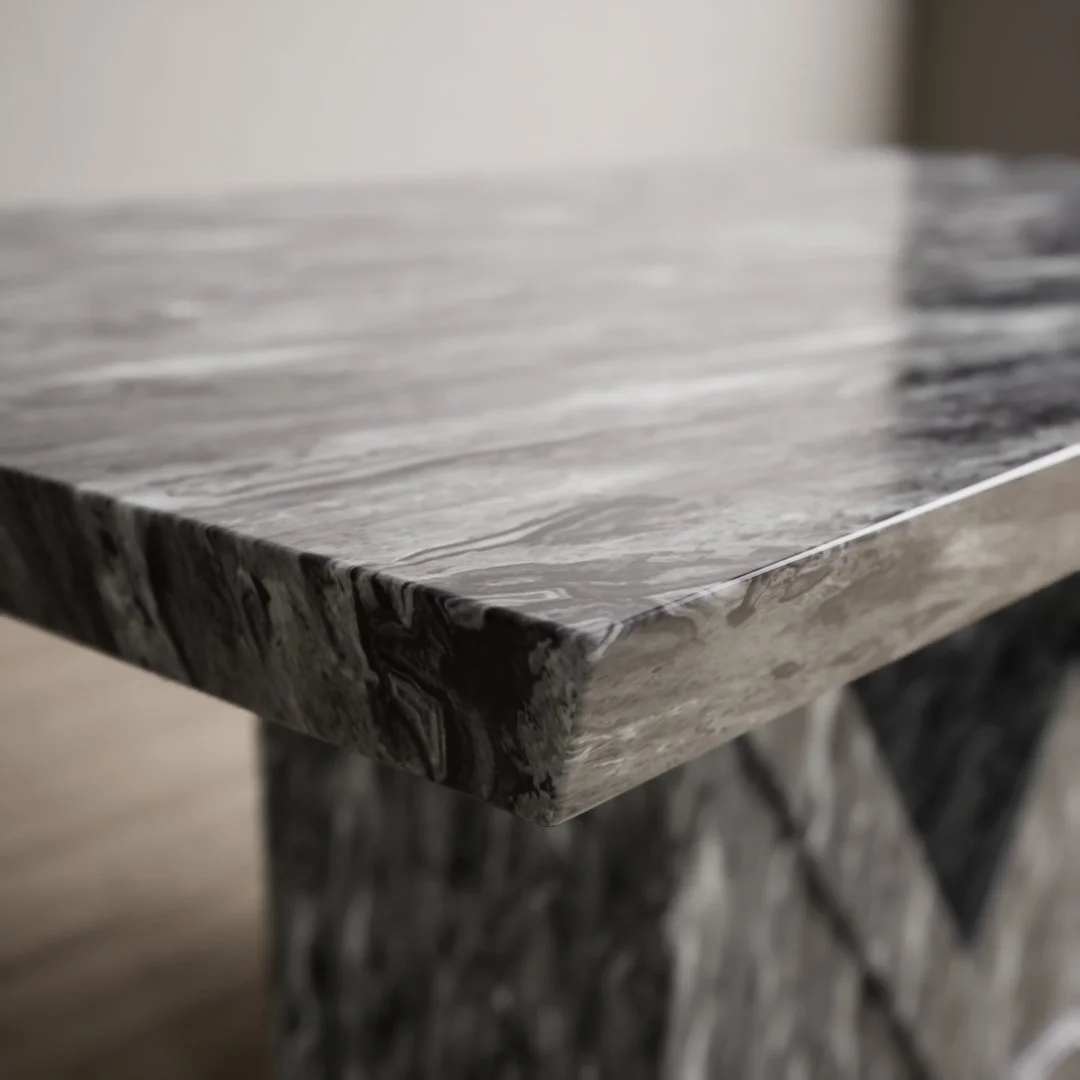 Close-up of a gray and white marbled stone table edge.