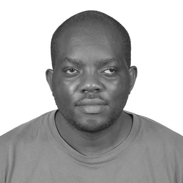 A young man with a shaved head and light brown skin, wearing a striped shirt, photographed against a blue background.