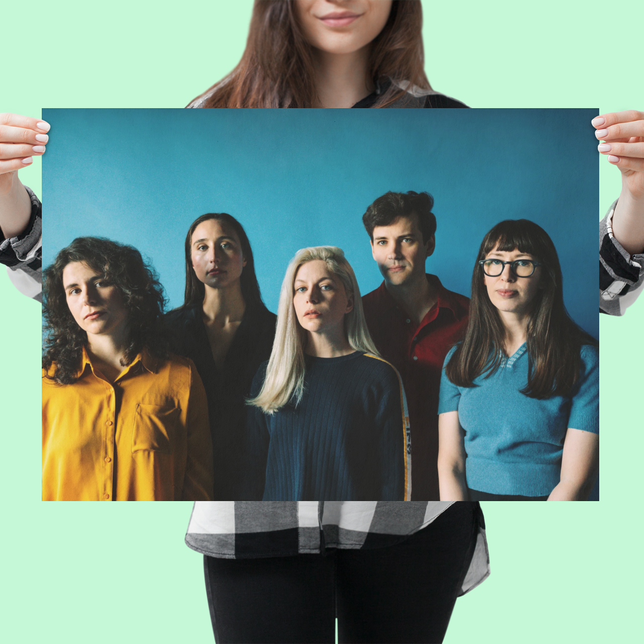 mockup-of-a-woman-holding-a-horizontal-poster-at-a-studio-1320-el_2_028eafb3-4f67-4bb4-9b29-b34d81d8a9d9.png