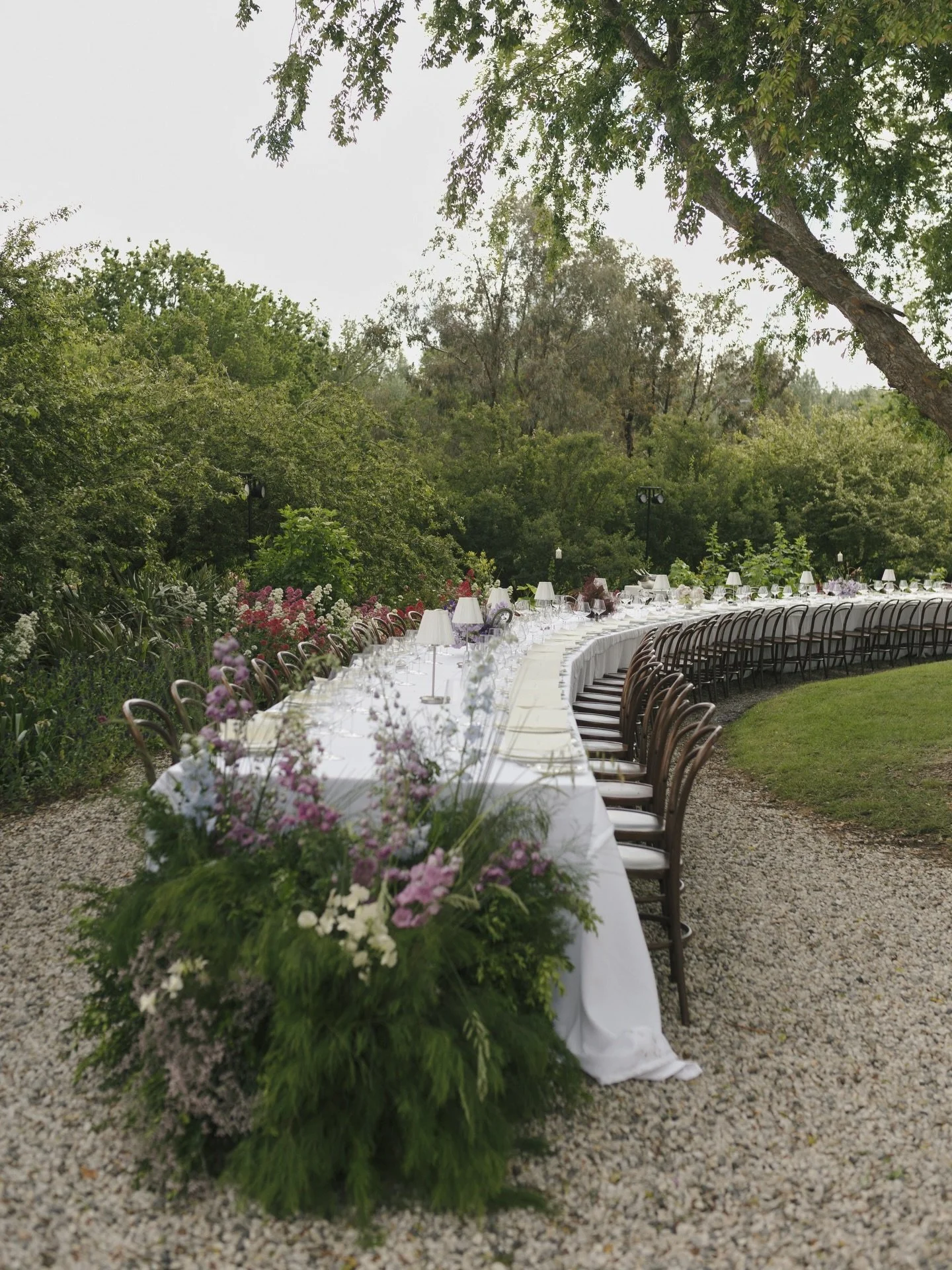 D&amp;M &ndash; Proven&ccedil;al Reverie
The vision for their wedding day was a French bistro - Intimate, atmospheric, and centred around food and conversation, on a long-curved table, which ran down the pebble driveway, layered with ivory linen, sil