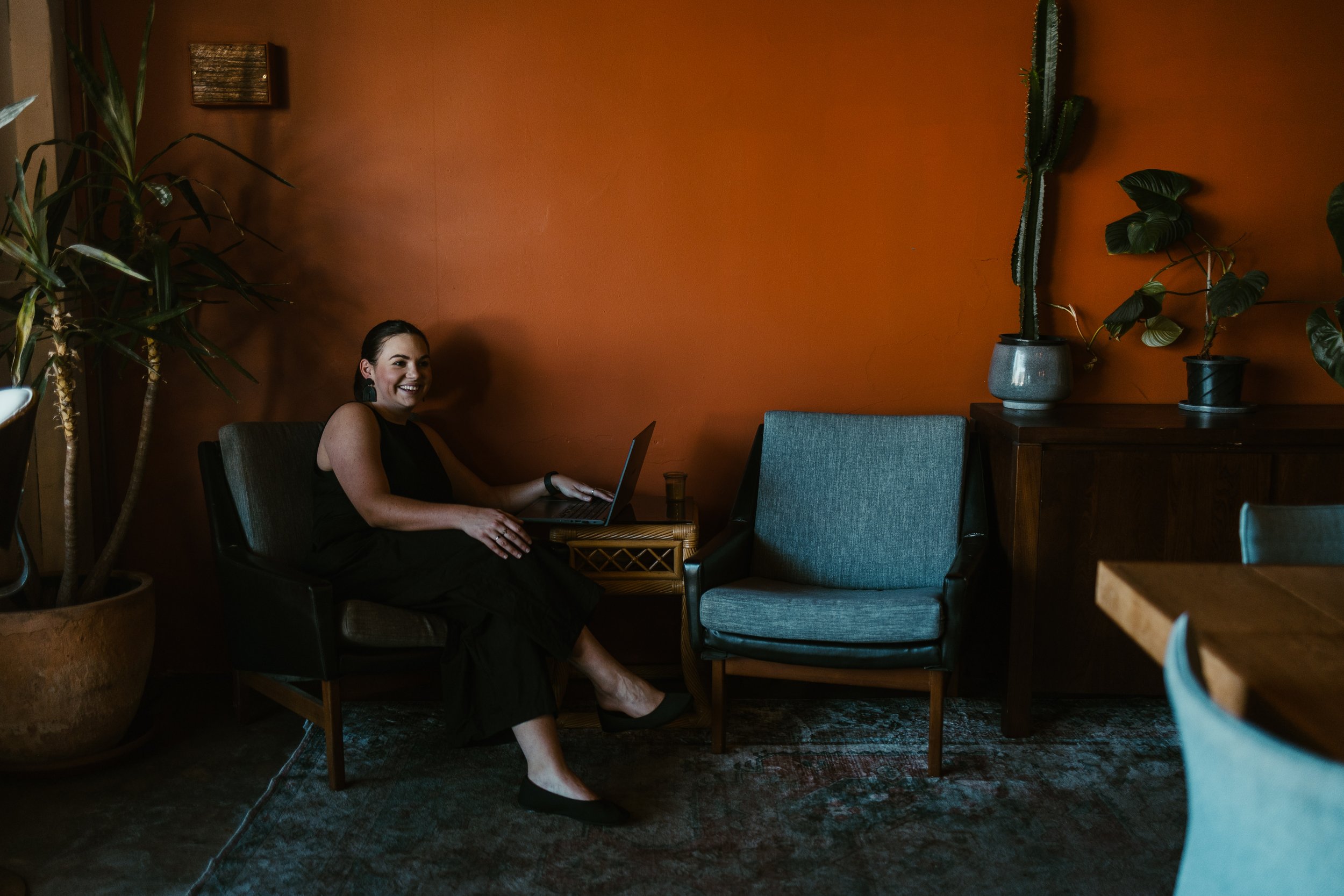 Candice Mulcahy, Melbourne funeral celebrant, seated in a warm Melbourne venue.