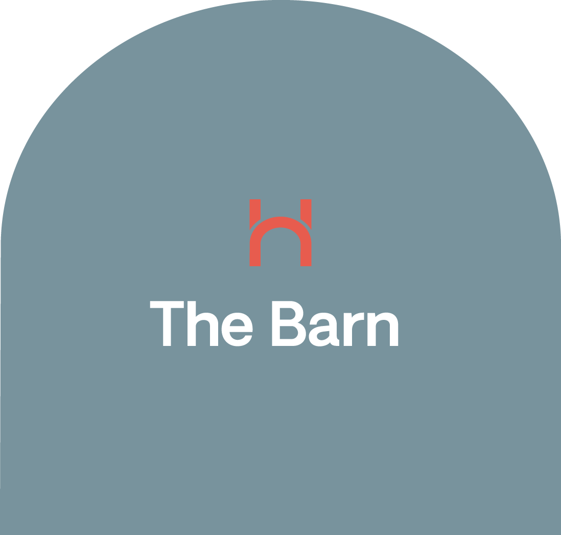 Logo with a red barn icon above the words "The Barn" on a blue background.
