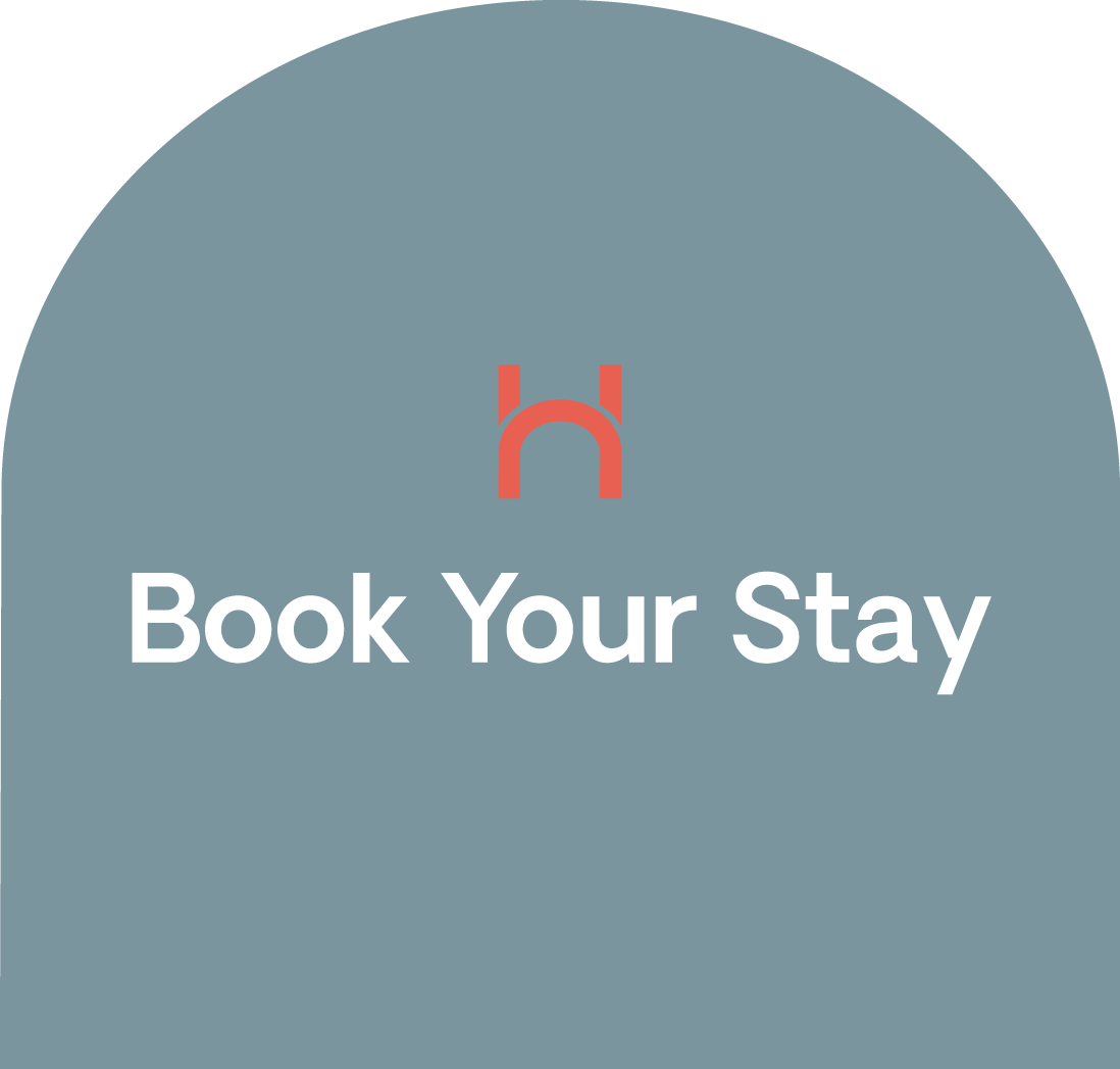 A booking app interface with a gray background, a red hotel icon, and white text that says 'Book Your Stay'.