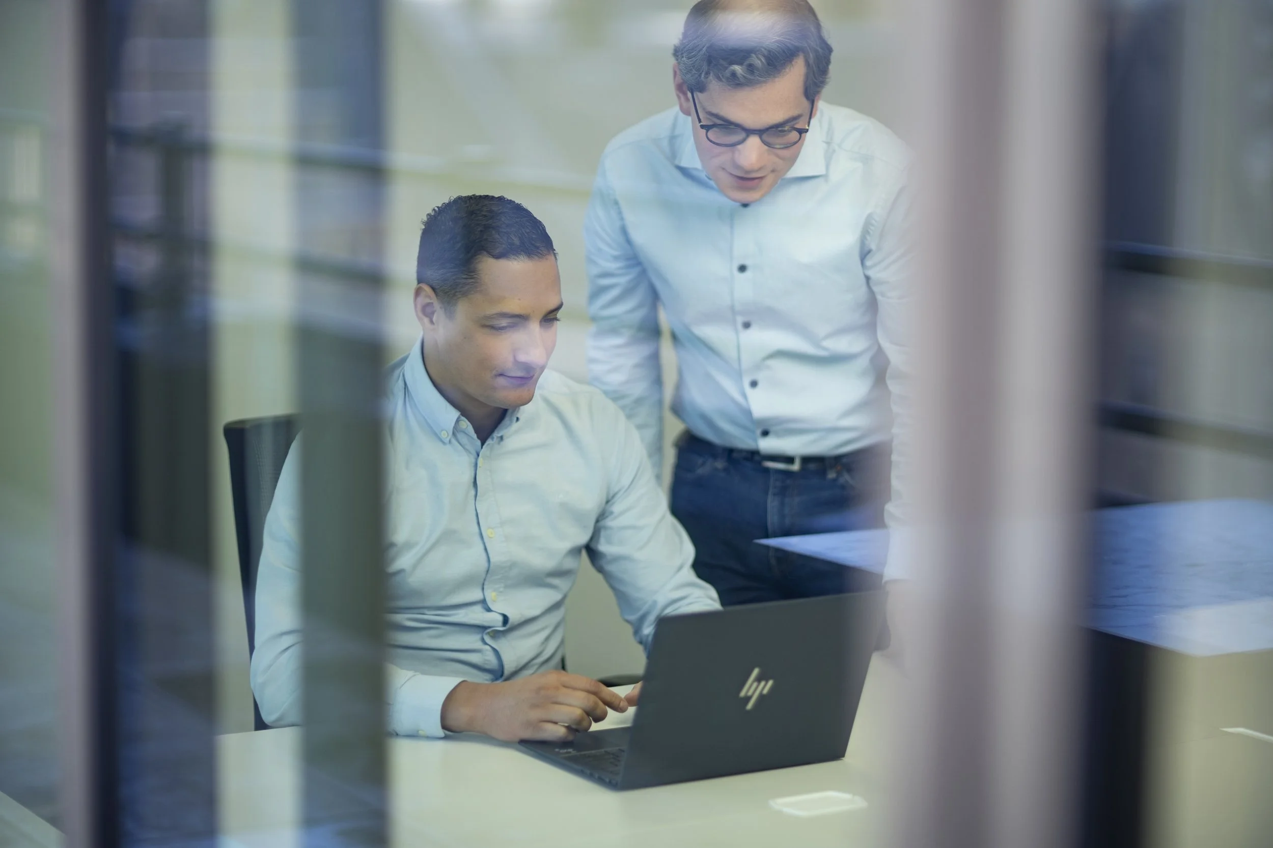 Two Triple Tax team members working together on a tax reporting solution.