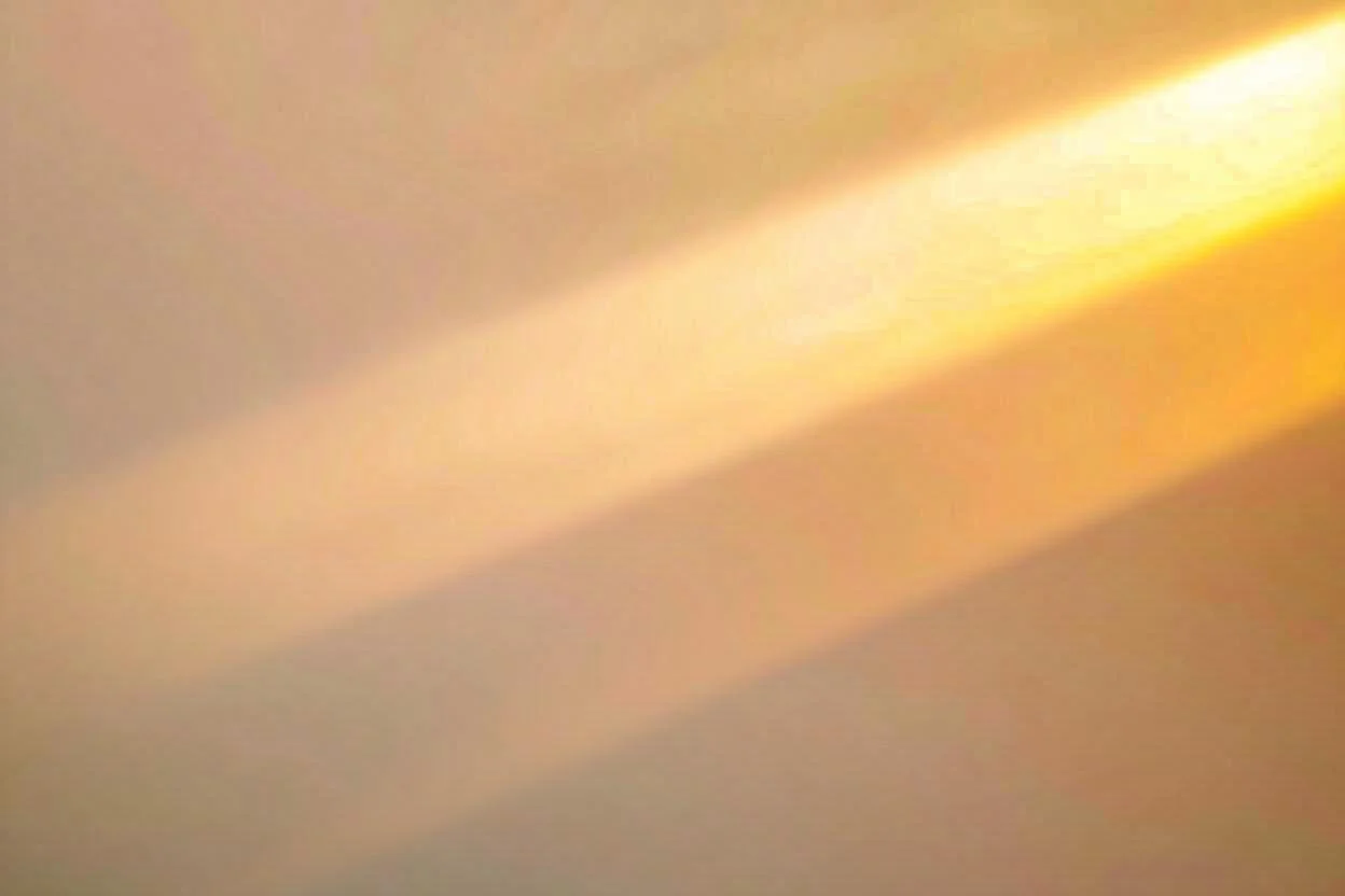 Abstract painting with a dominant yellow sun-like shape at the top center, radiating colors downward into a blend of soft blues and greens, creating a luminous, spiritual atmosphere.