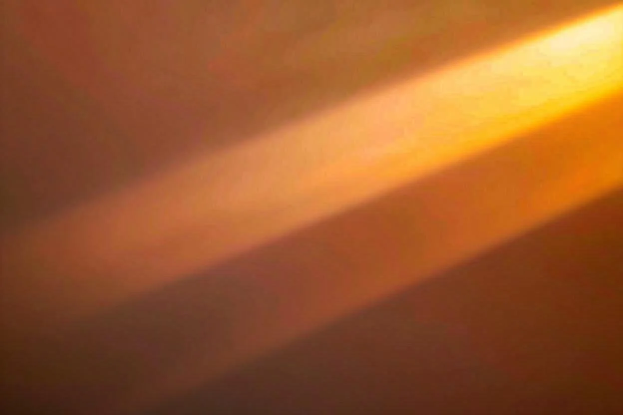 Abstract painting with a dominant yellow sun-like shape at the top center, radiating colors downward into a blend of soft blues and greens, creating a luminous, spiritual atmosphere.