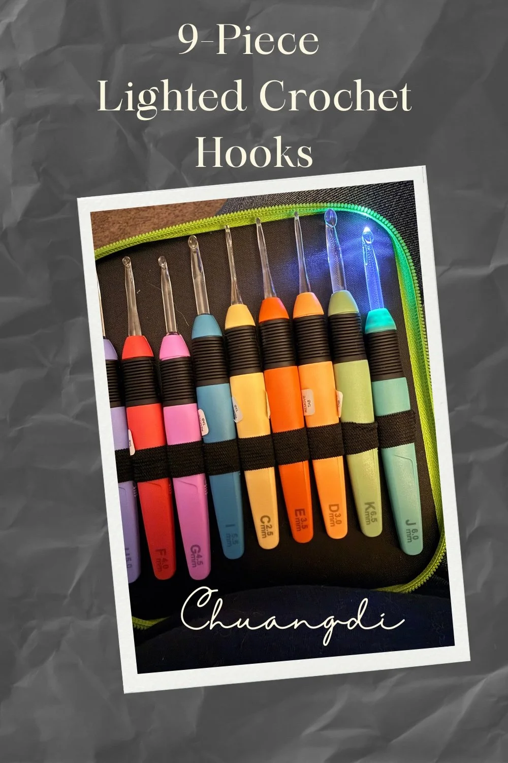 Colorful set of nine lighted crochet hooks in a black case with green zipper, with the brand name 'Chuangdi' written in cursive.